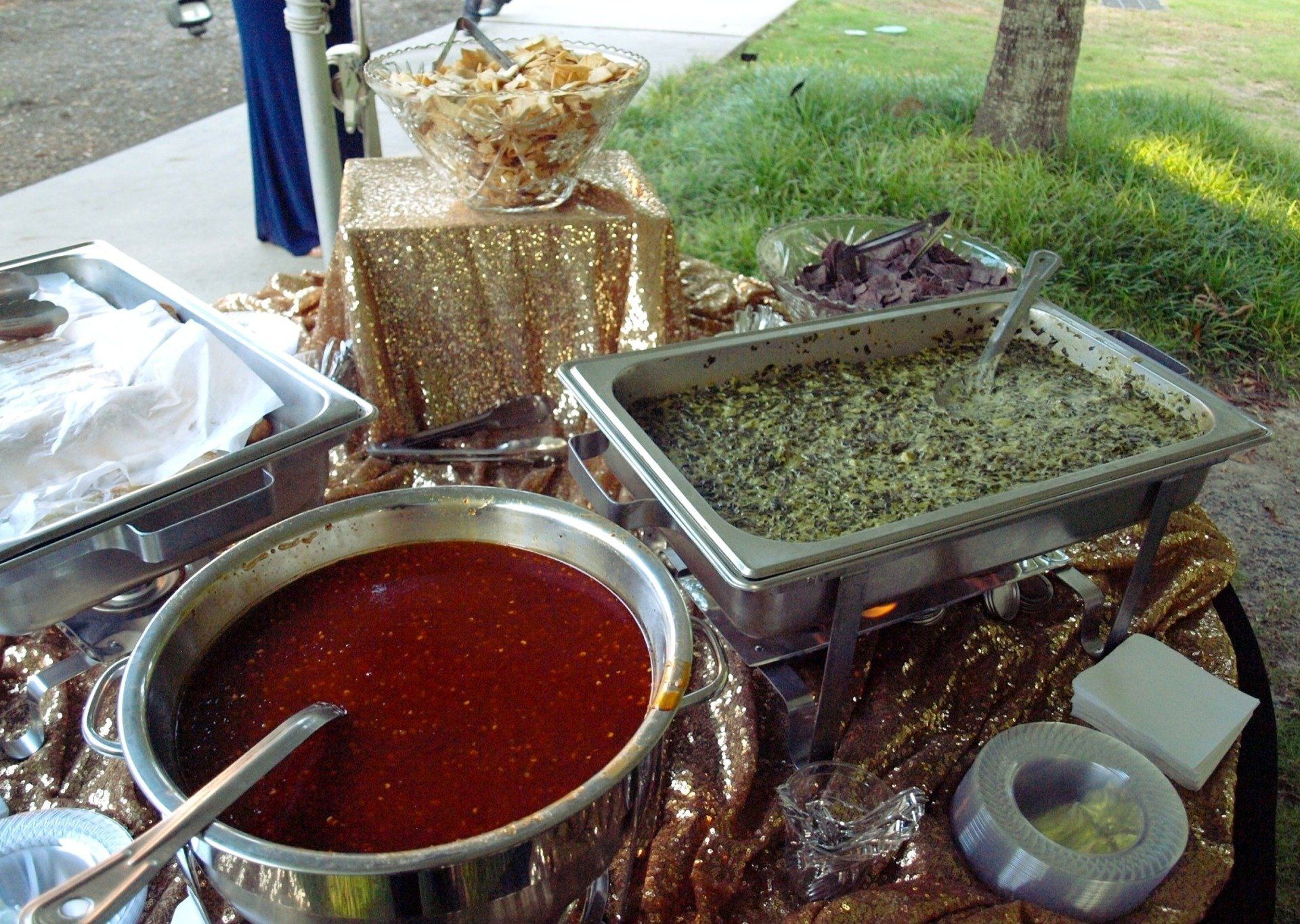 chafing dish of egg roll dipping sause and buffet pan of spinach dip