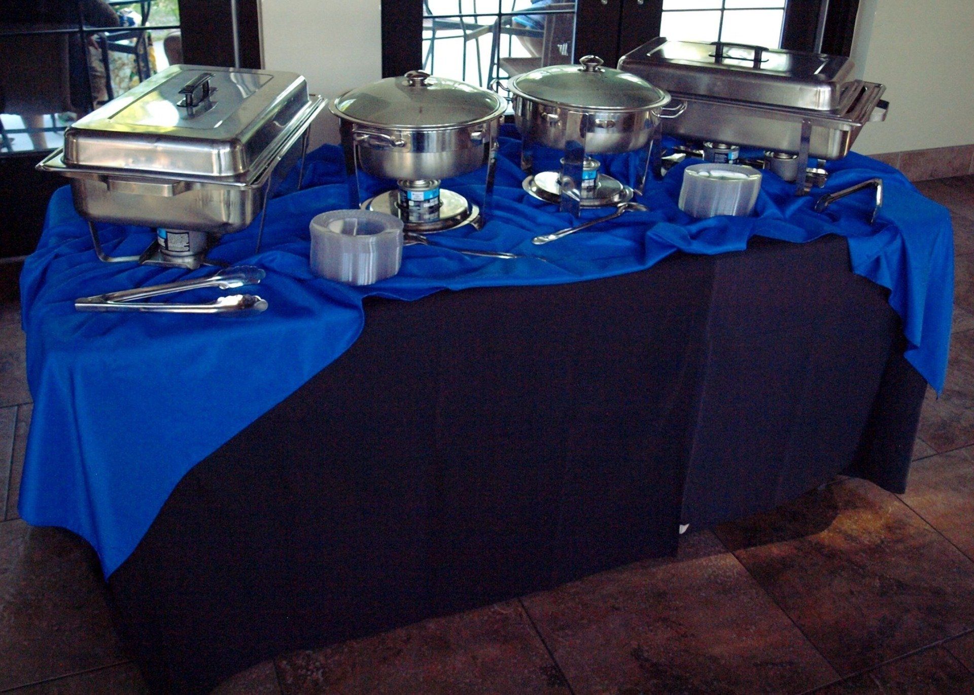 small table set with buffet pans and chafing dishes