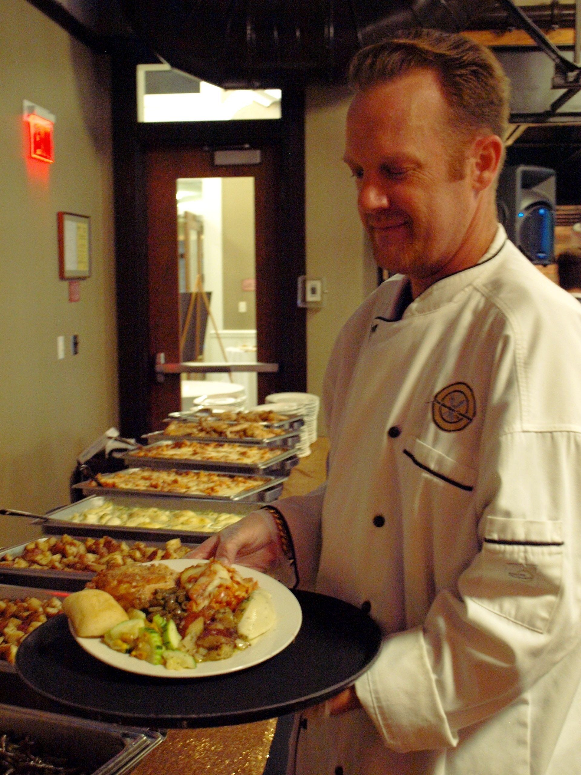 male caterer with a plate of food