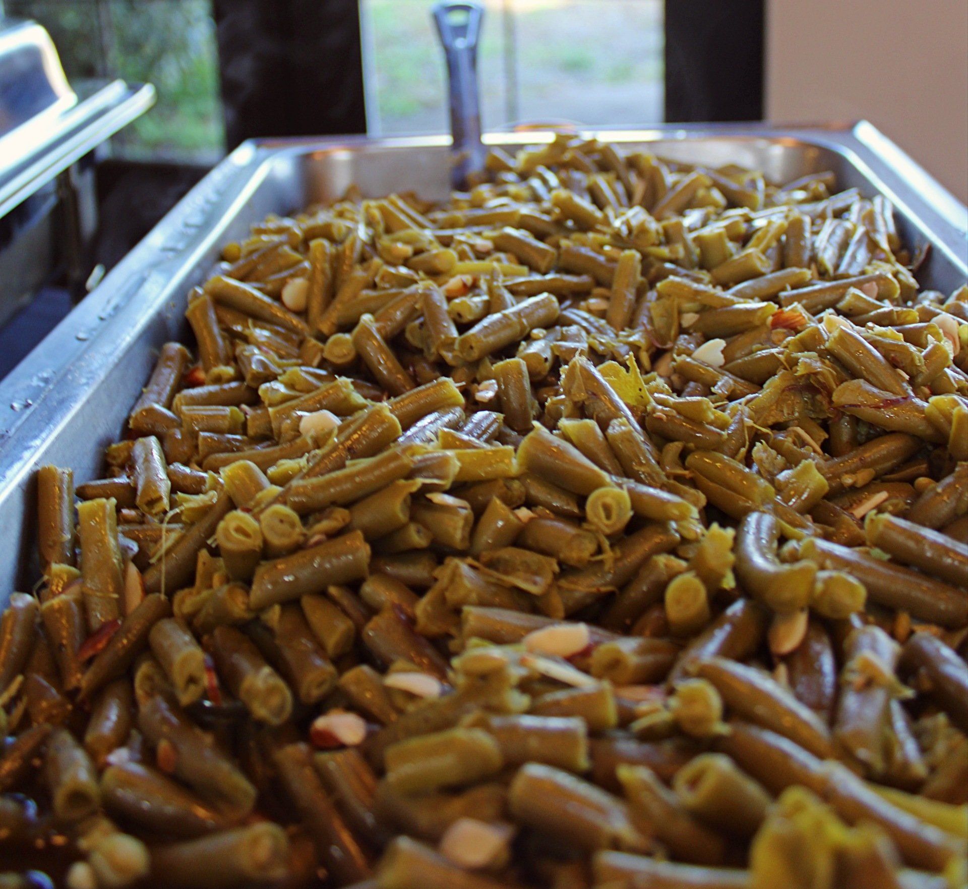 buffet pan filled with grean beans and slivered almonds