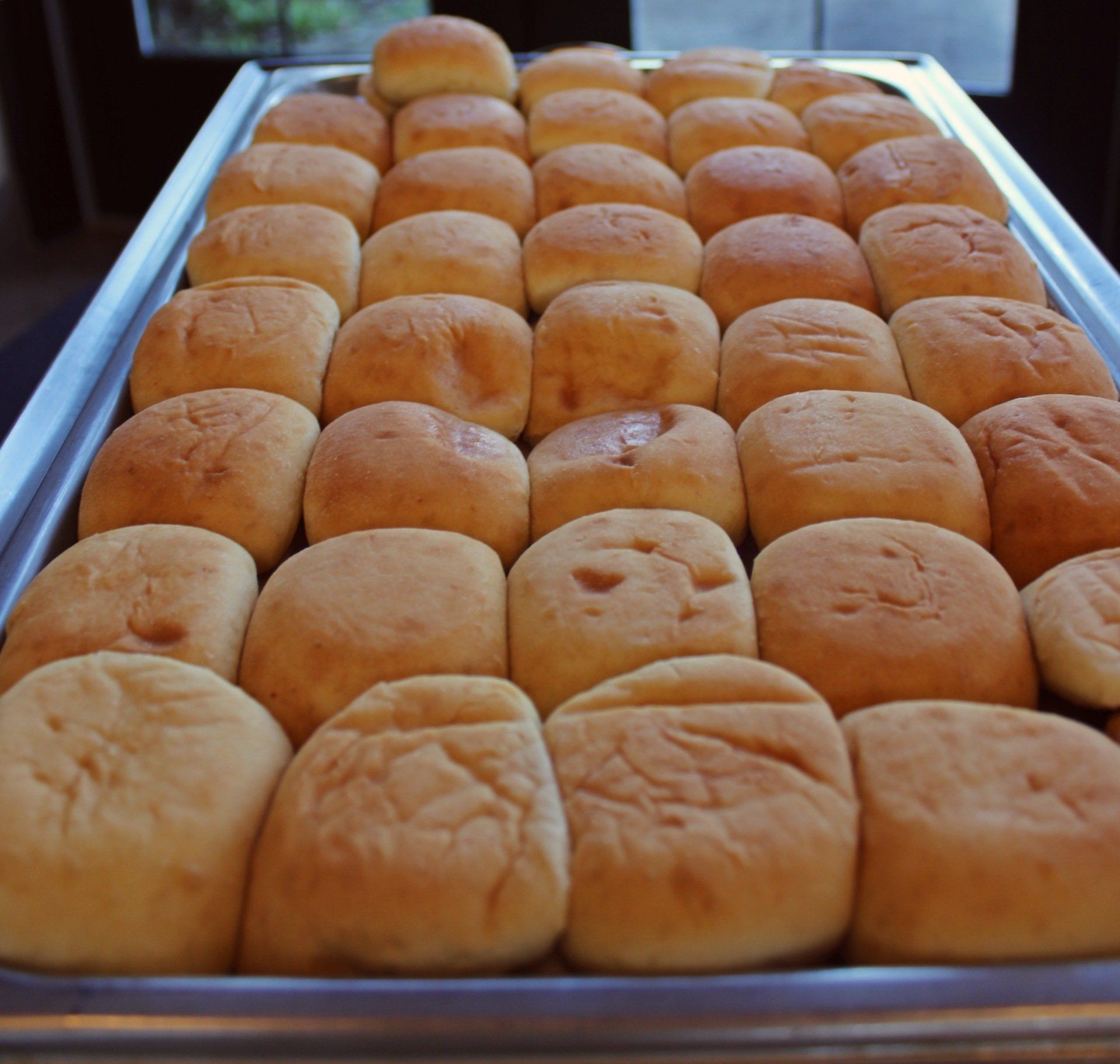 buffet pan filled with fresh baked rolls