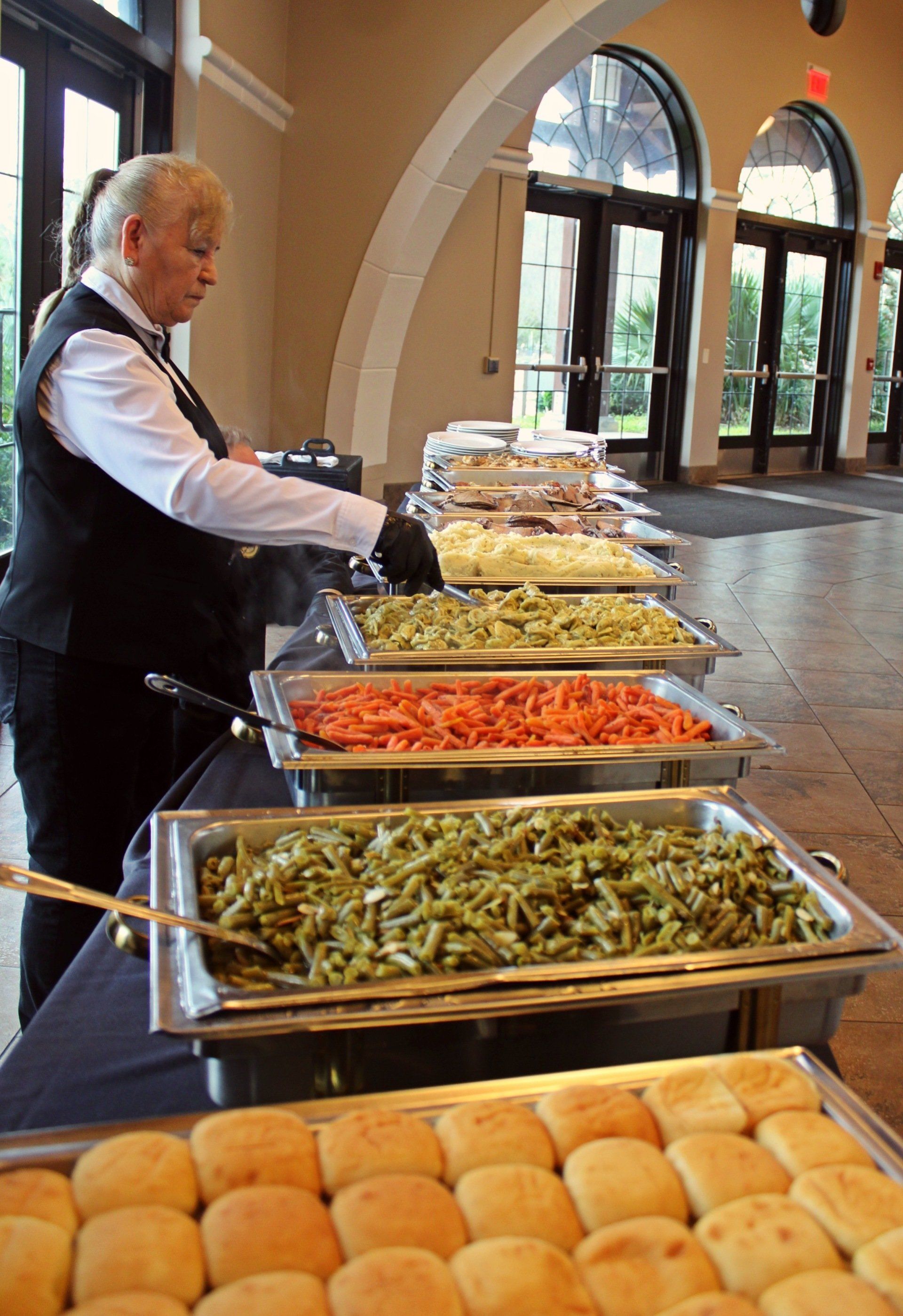 female caterer seting up a buffet table