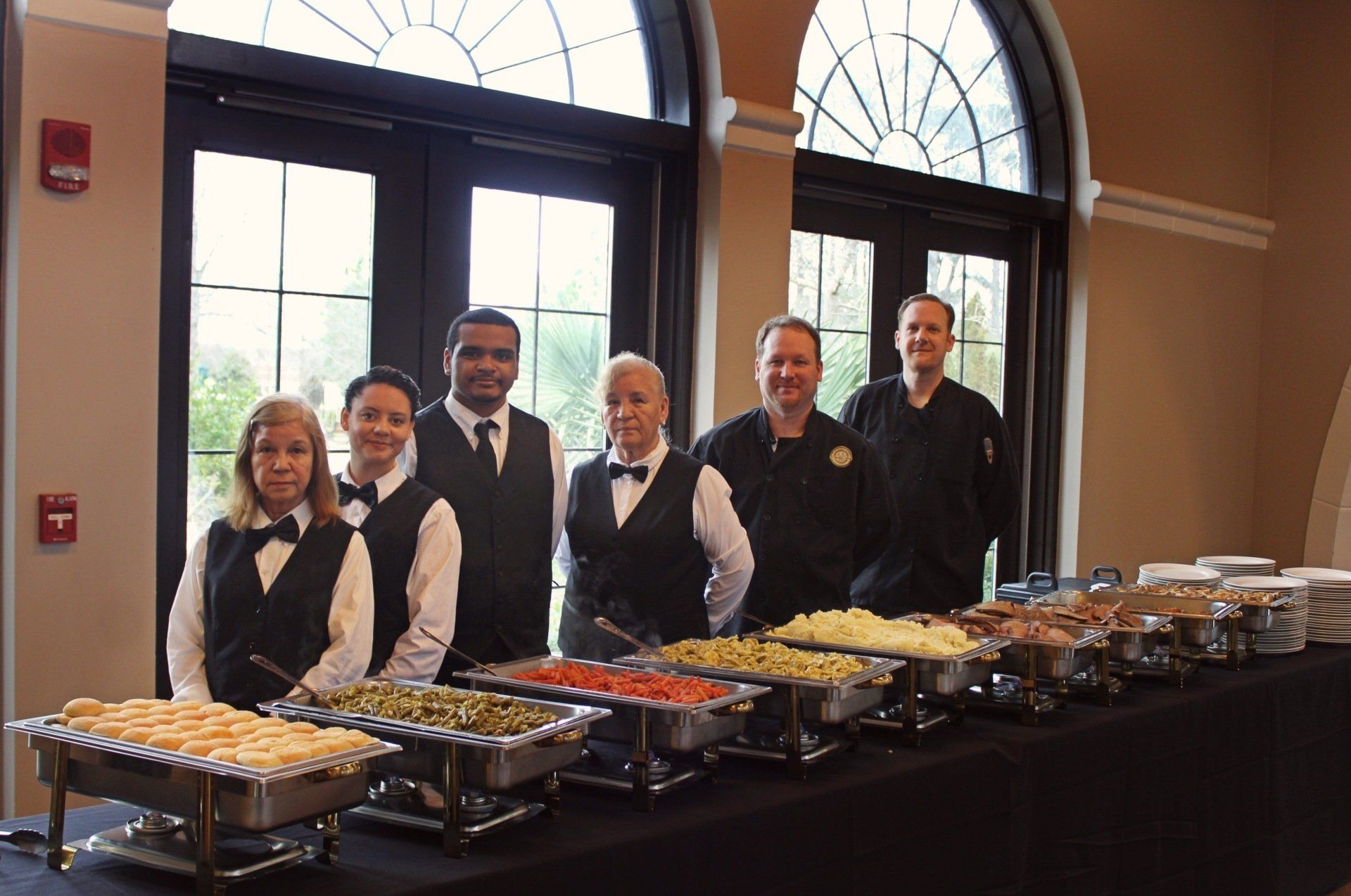 group of caterers standing behing buffet table at Botanical Gardens venue