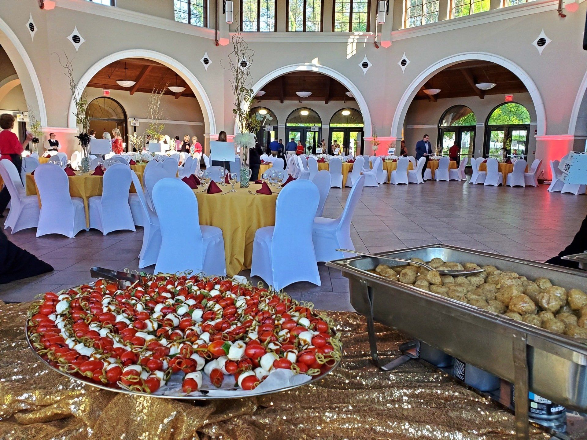 tray of caprese skewers and pan of meatballs
