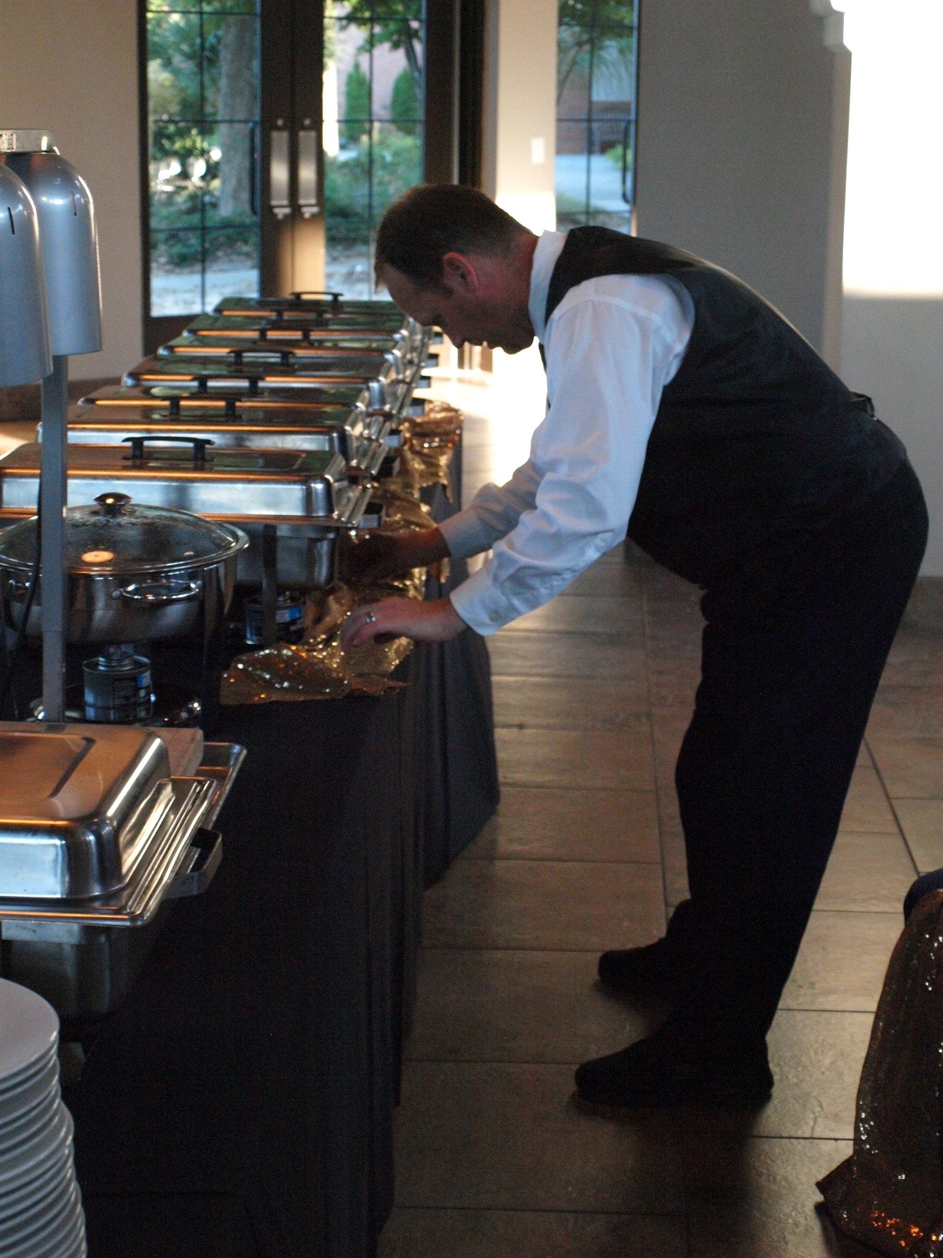 caterer setting up buffet table