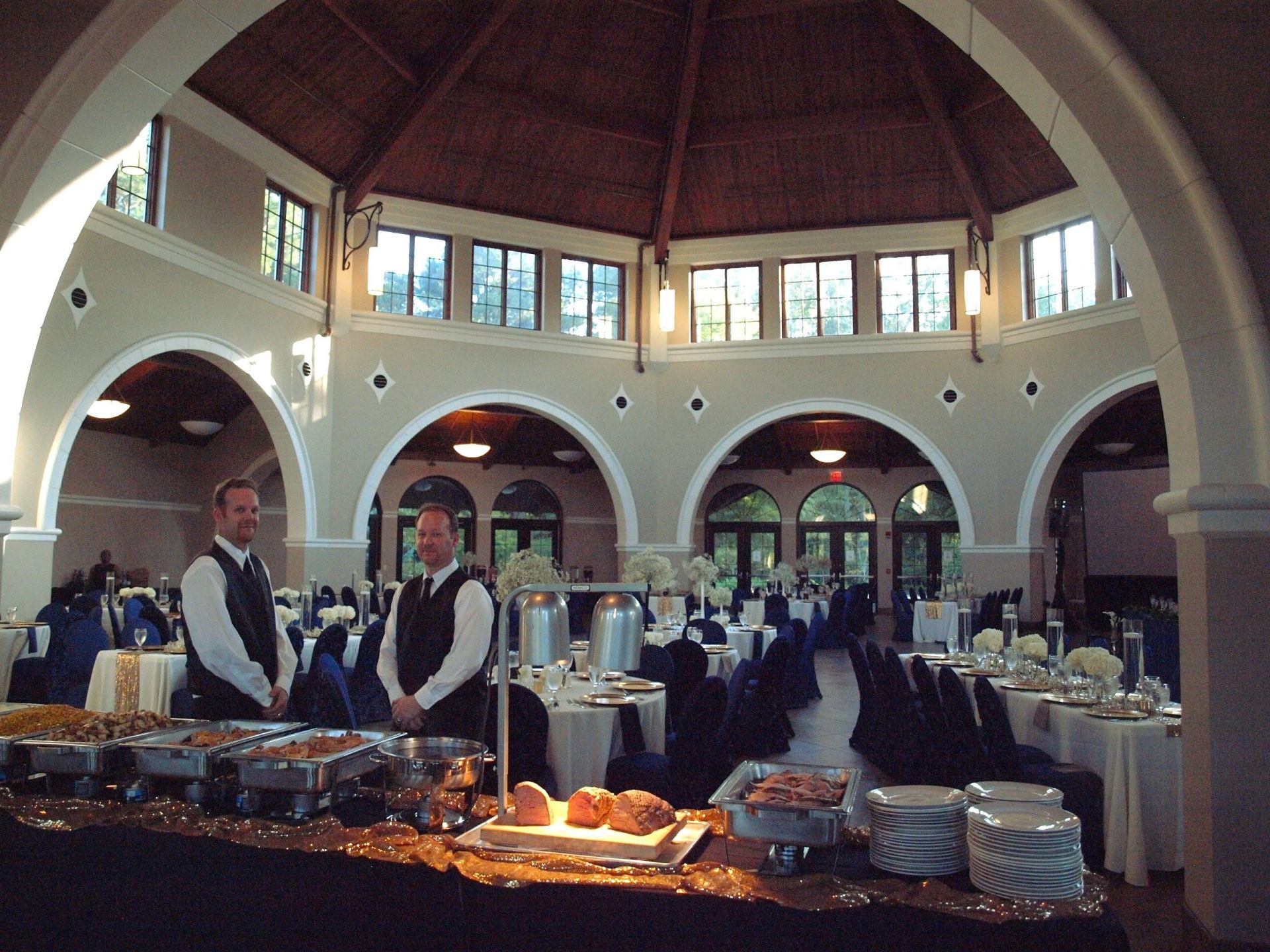 2 male caterers standing in a set up events space at Botanical Gardens venue