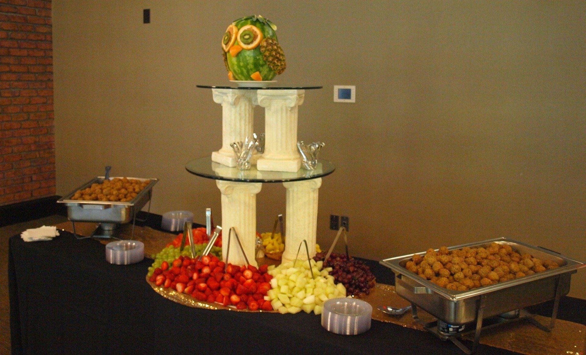 3 tiered fruit display with a fruit owl display on top