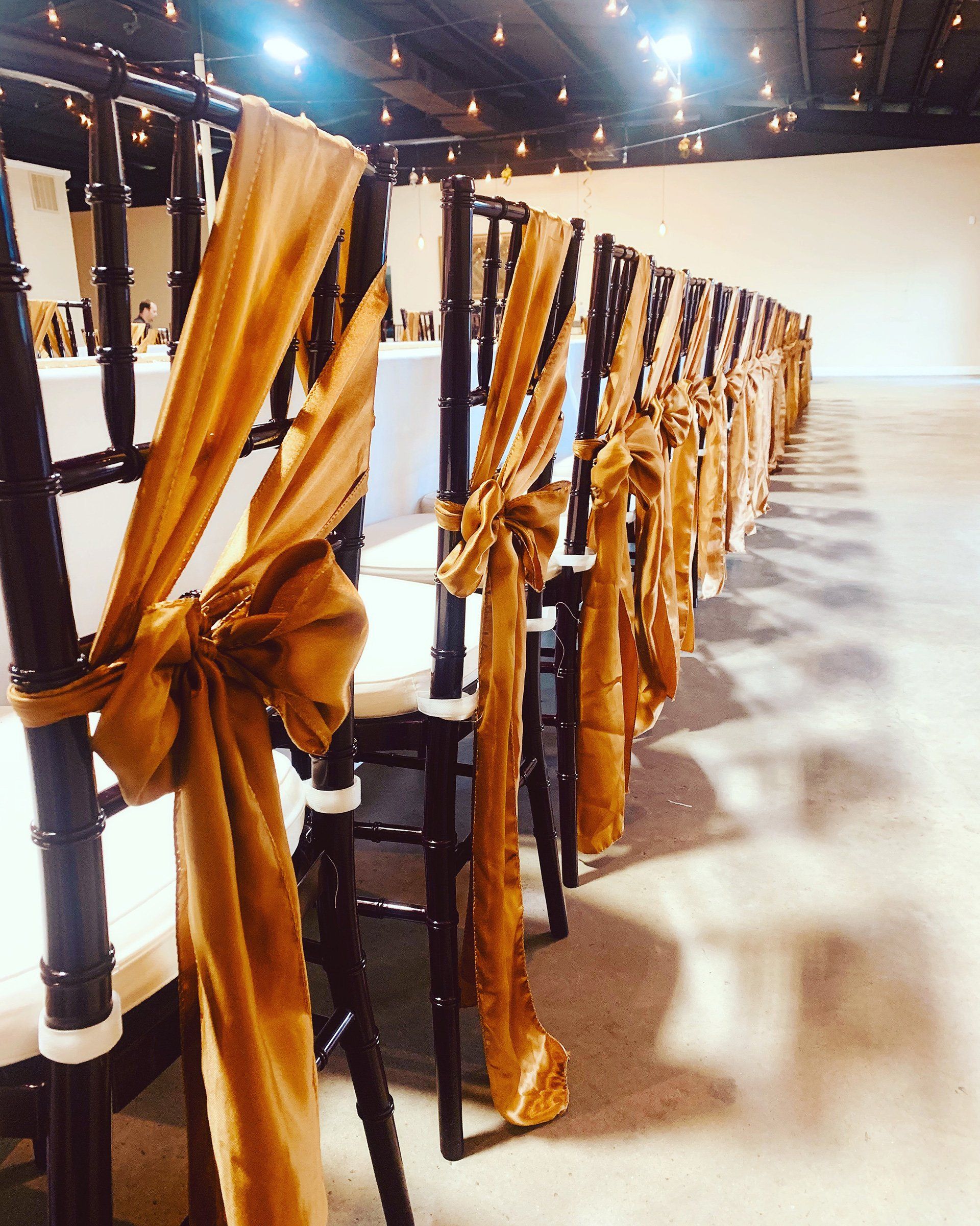 decorated chairs lined up along a long table