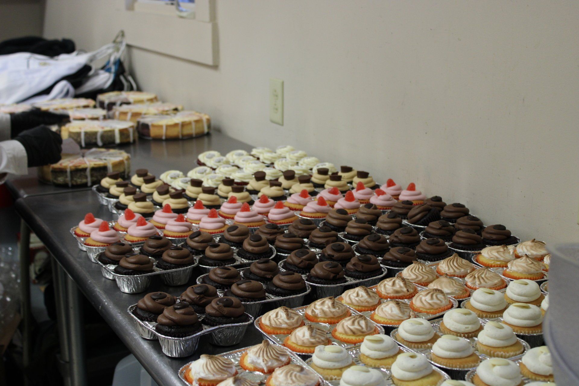 trays of assorted decorated cupcakes