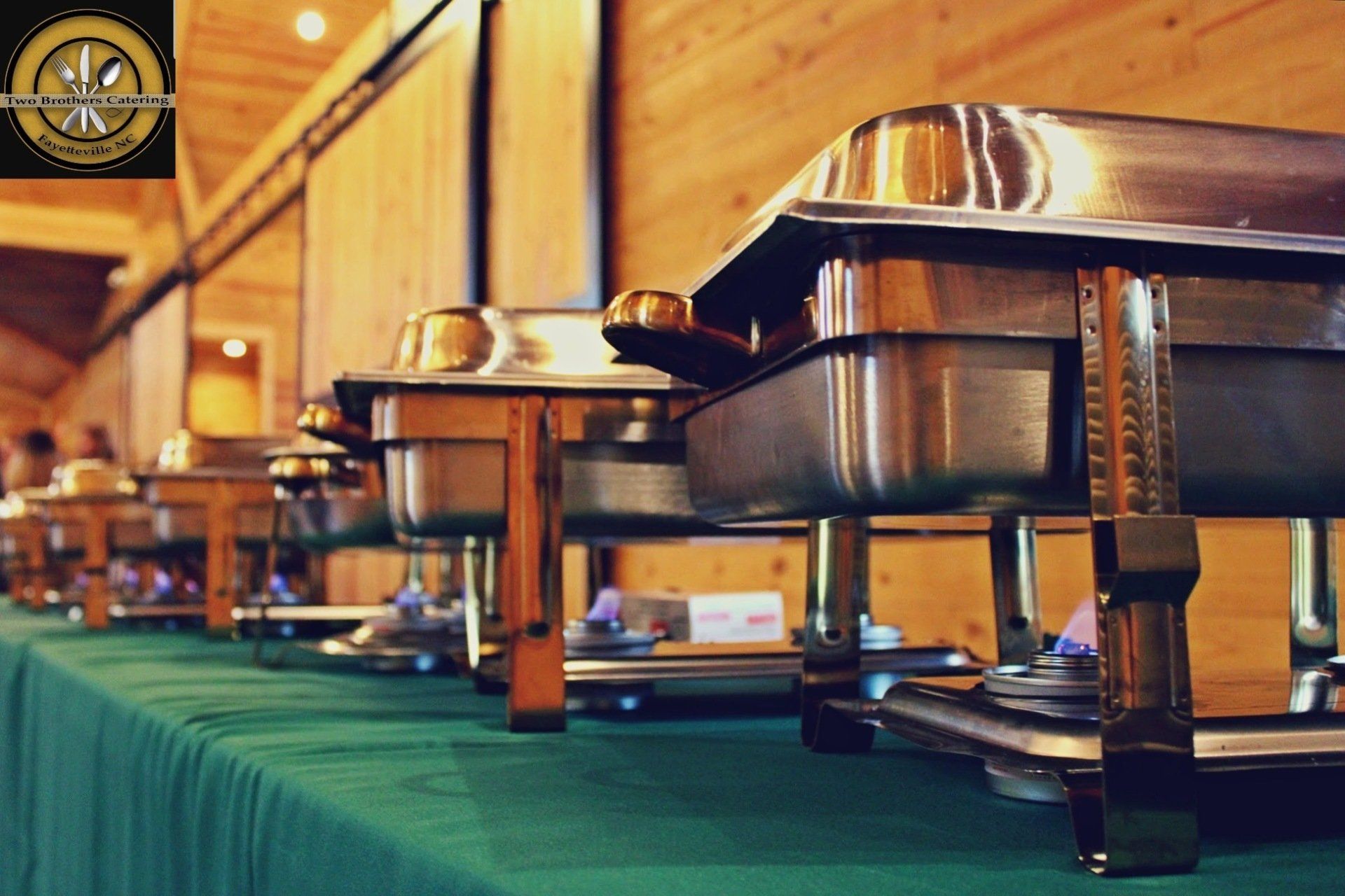 covered buffet pans lined up on buffet table