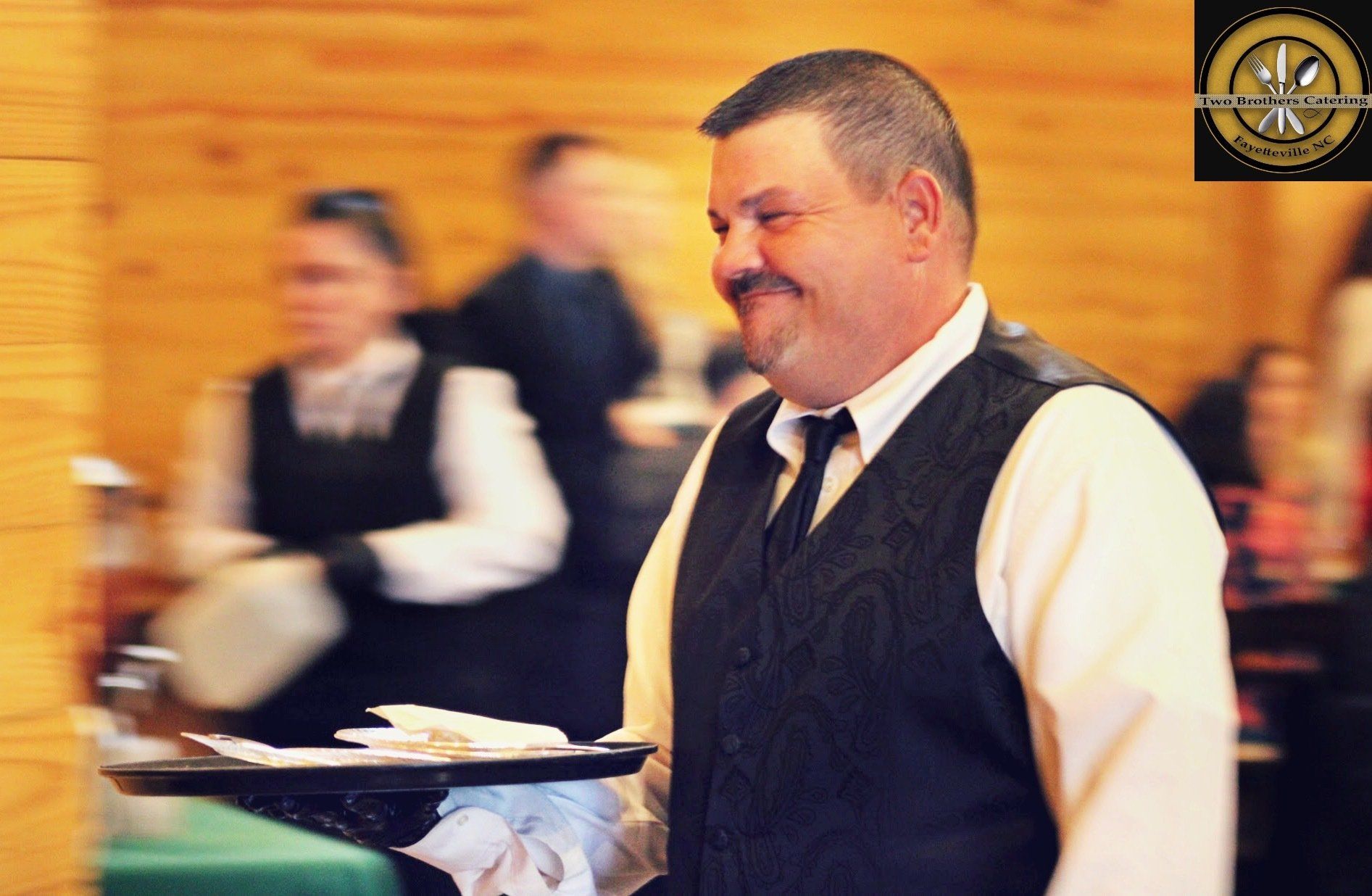 male caterer carrying a tray