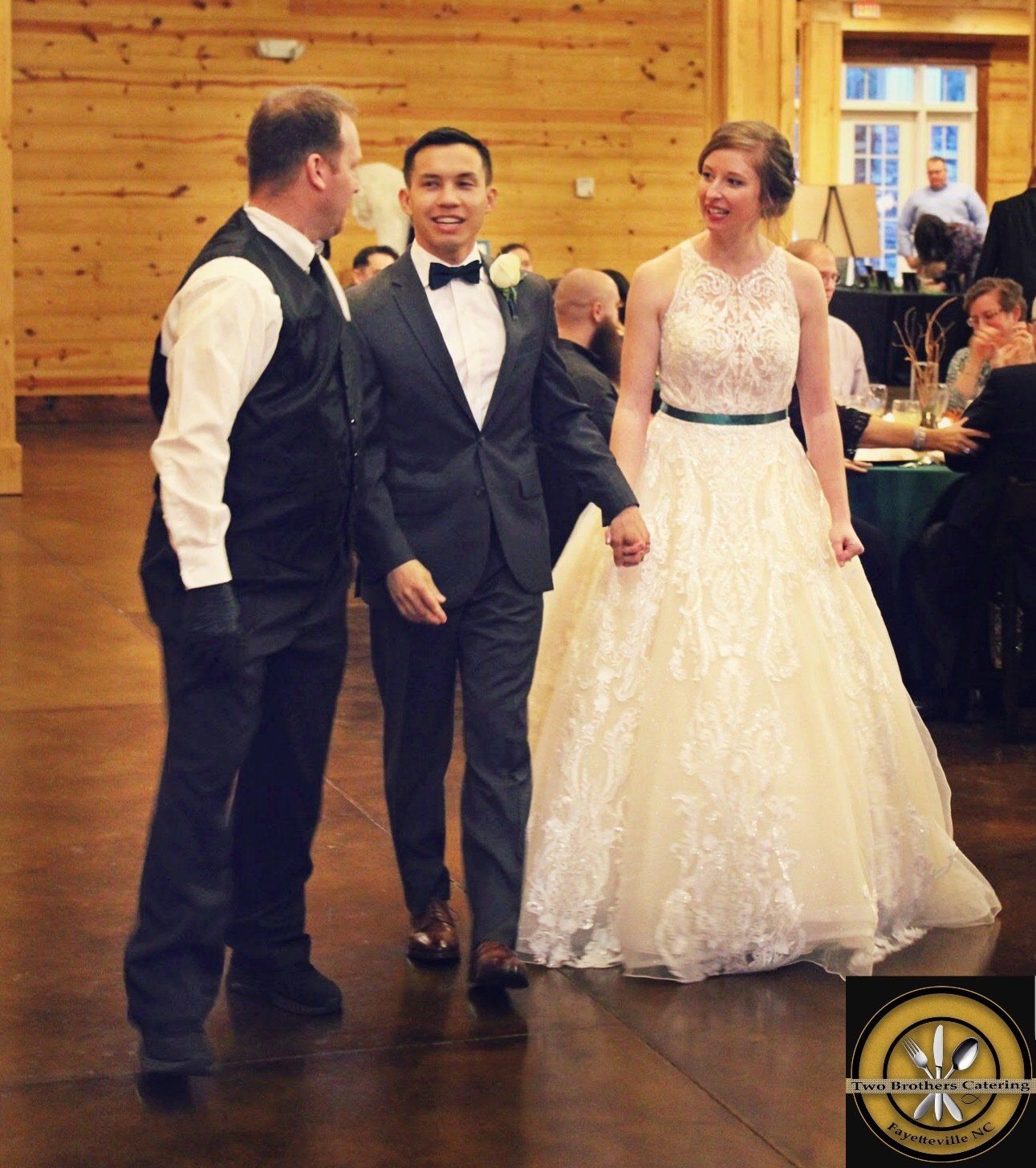 wedding couple speaking with male caterer