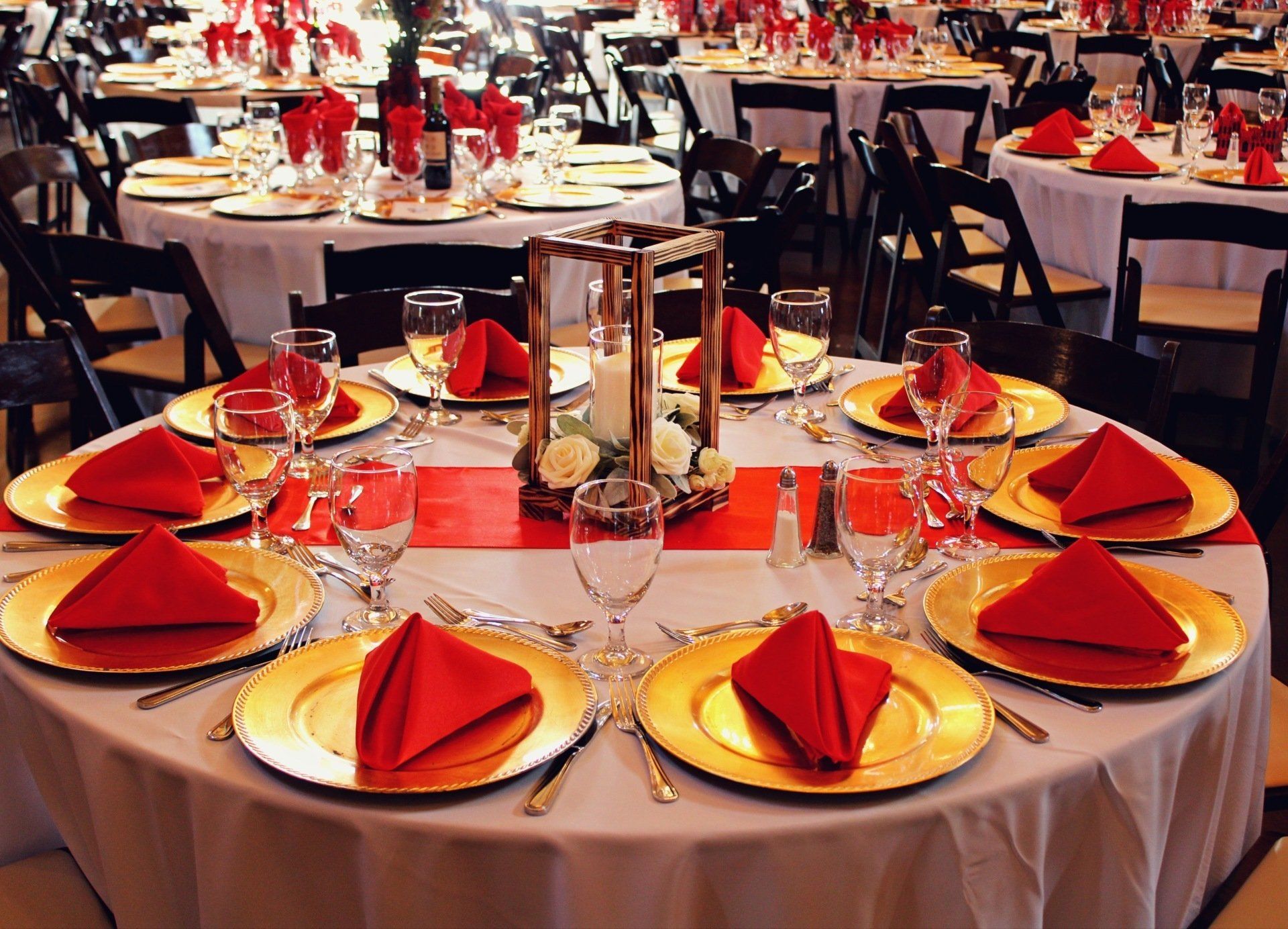 round table set up with red and gold decor