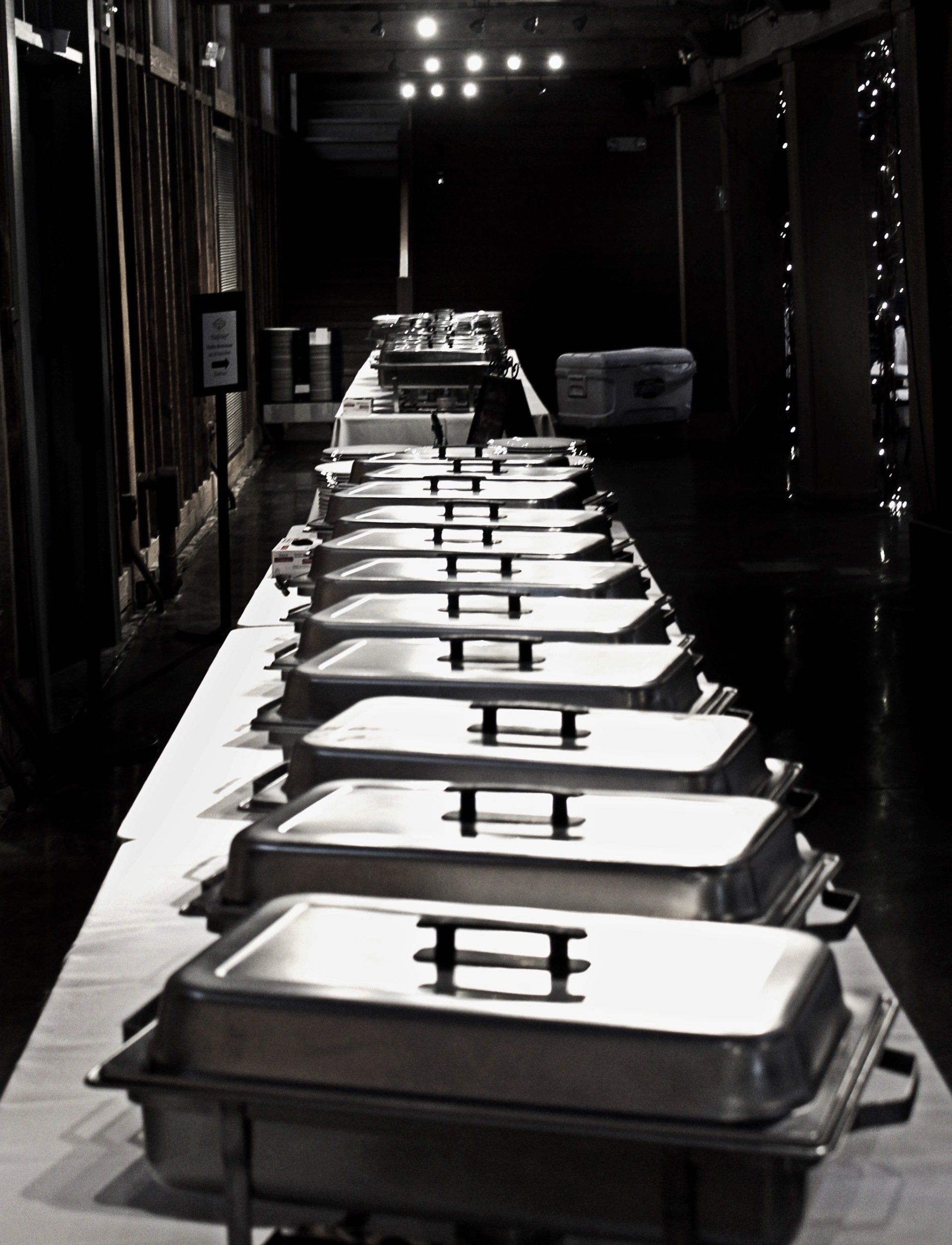 covered buffet trays lined up on buffet table