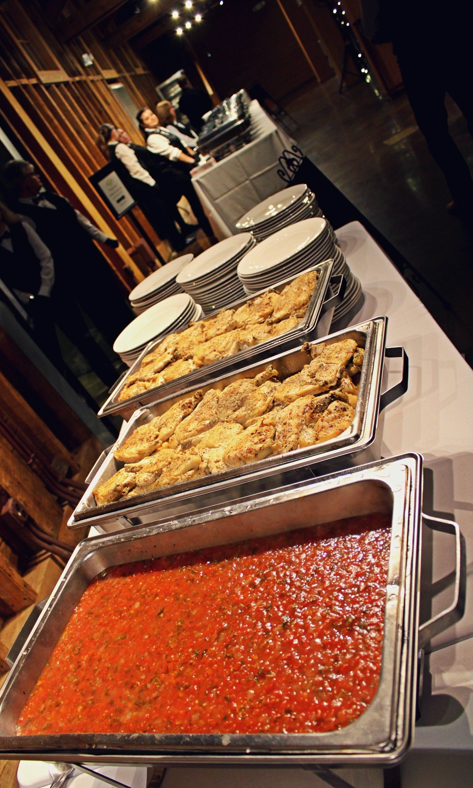 buffet trays of food lined up on buffet table