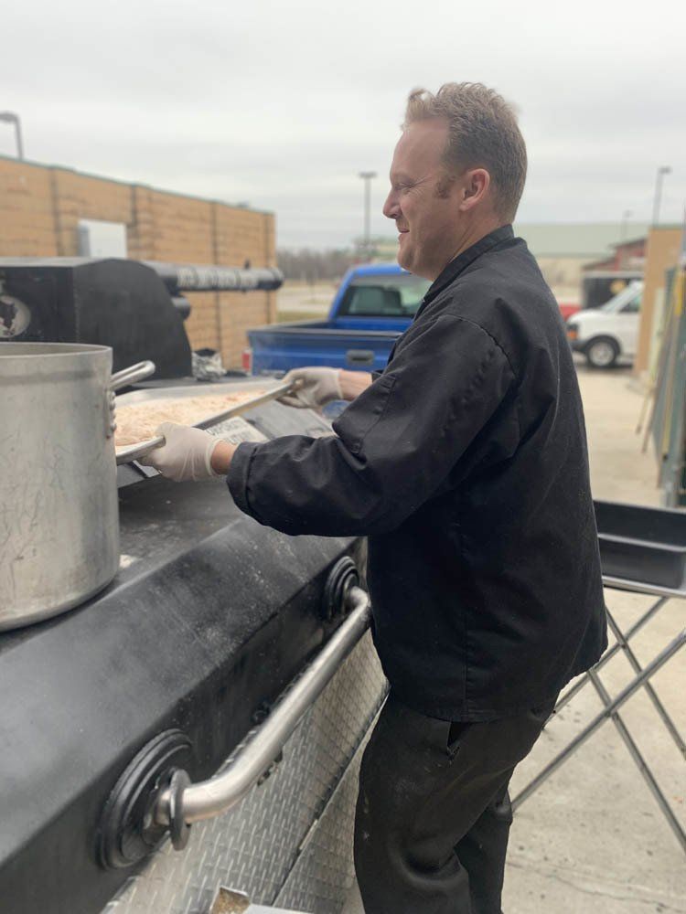 caterer pulling out a tray of food