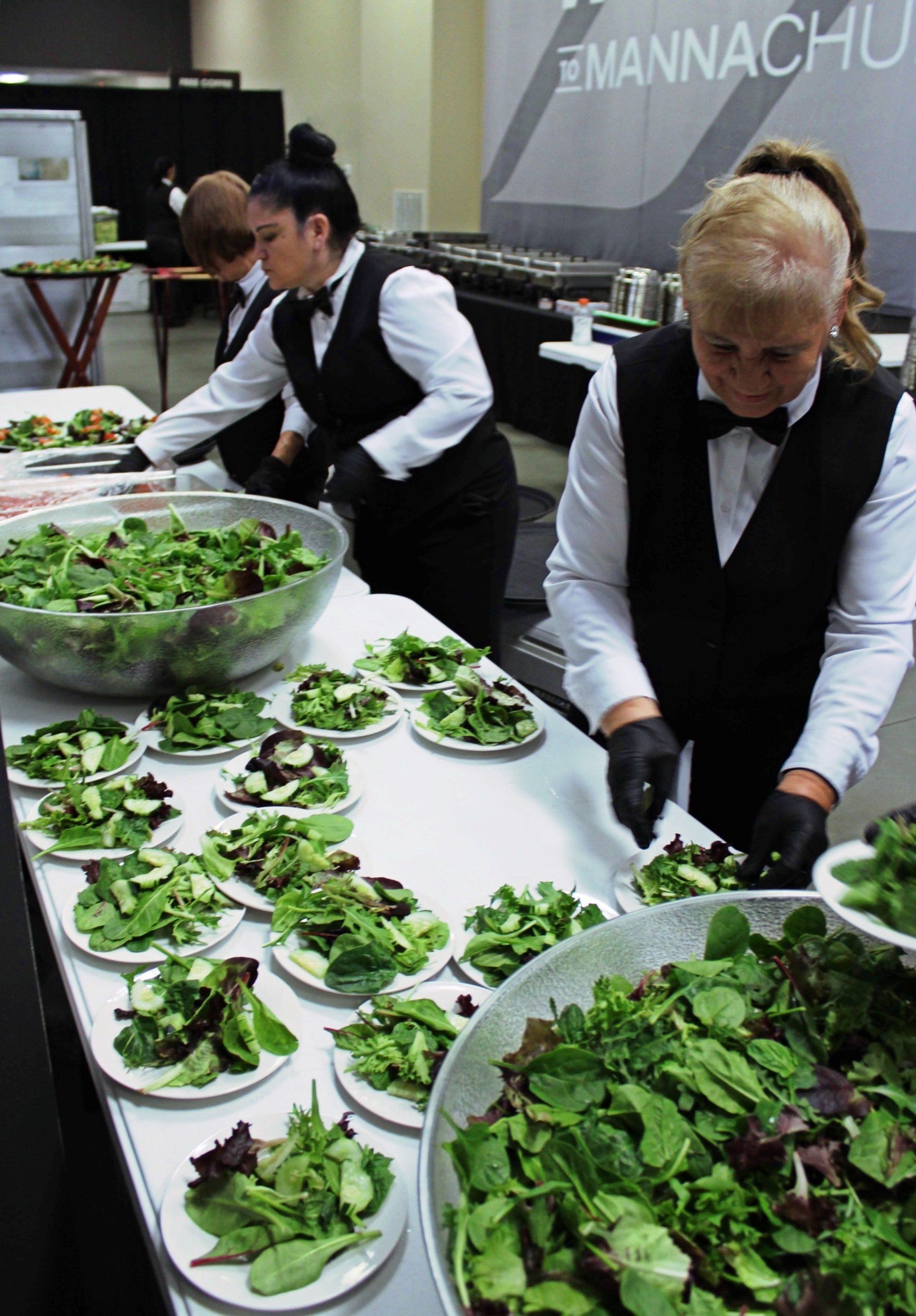 caterers plating salads at Manna Church venue
