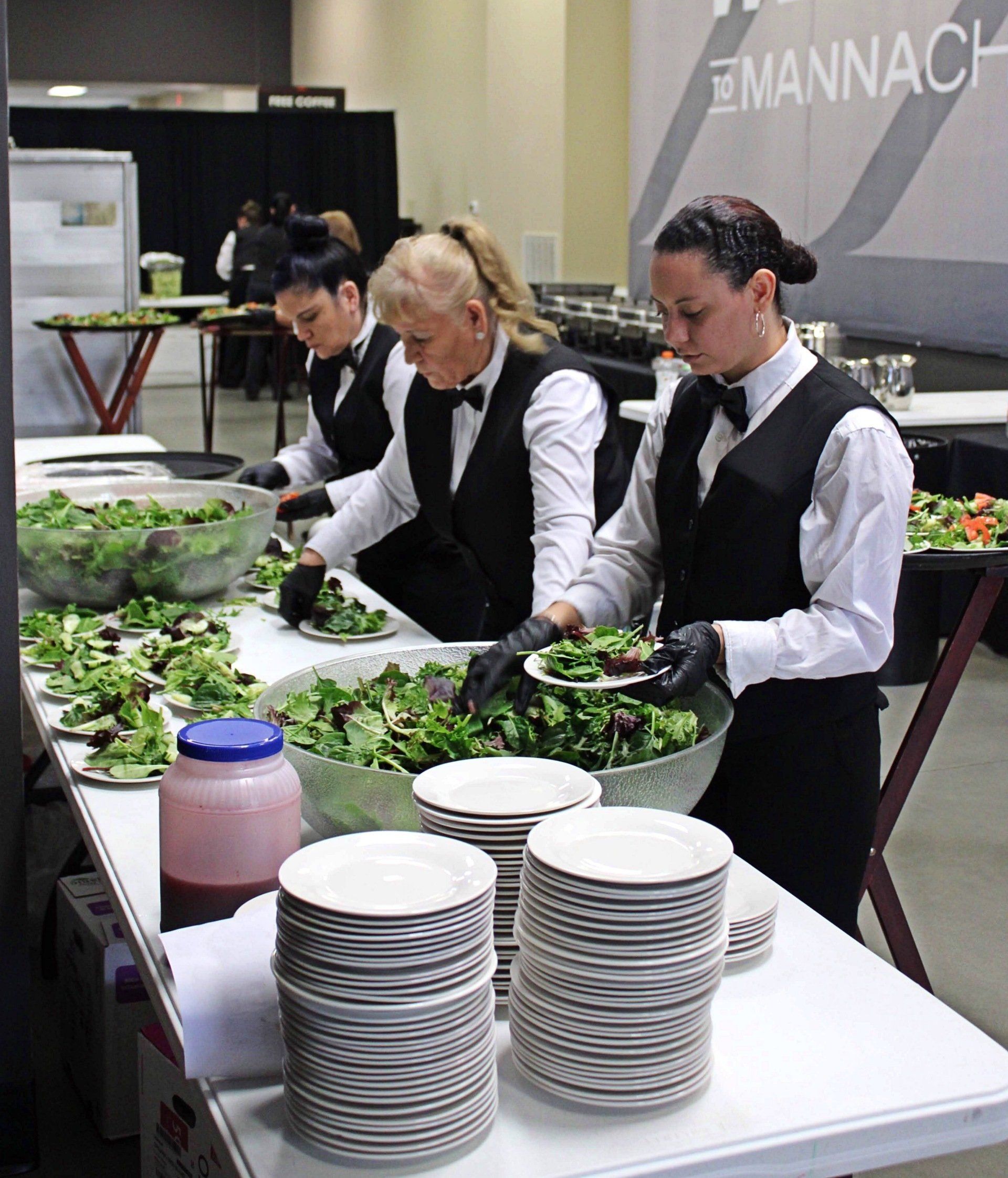 female caterers plating salads
