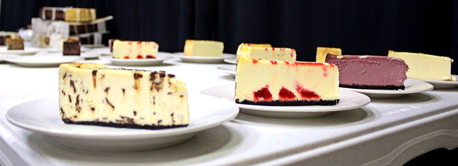 dessert table with slices of assorted cheese cake