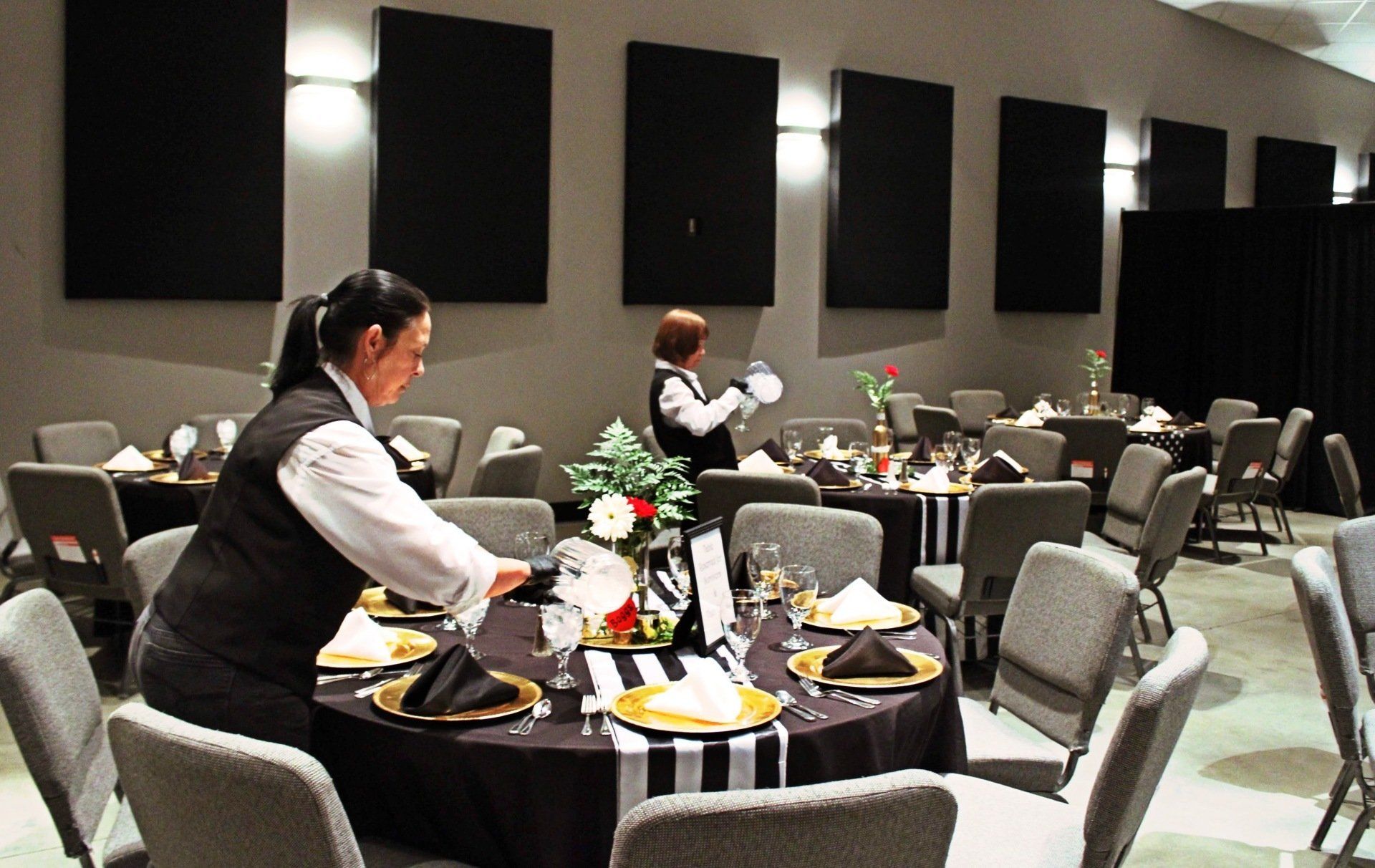 female caterers filling water glasses