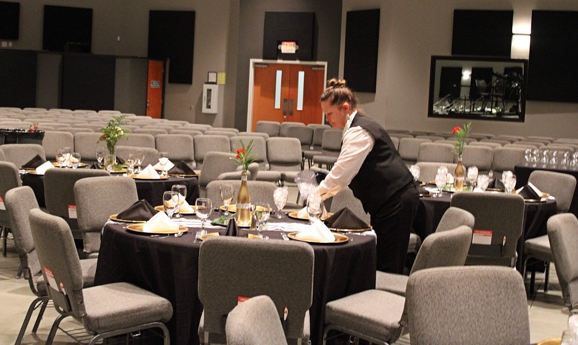 female caterer setting table at Manna Church venue