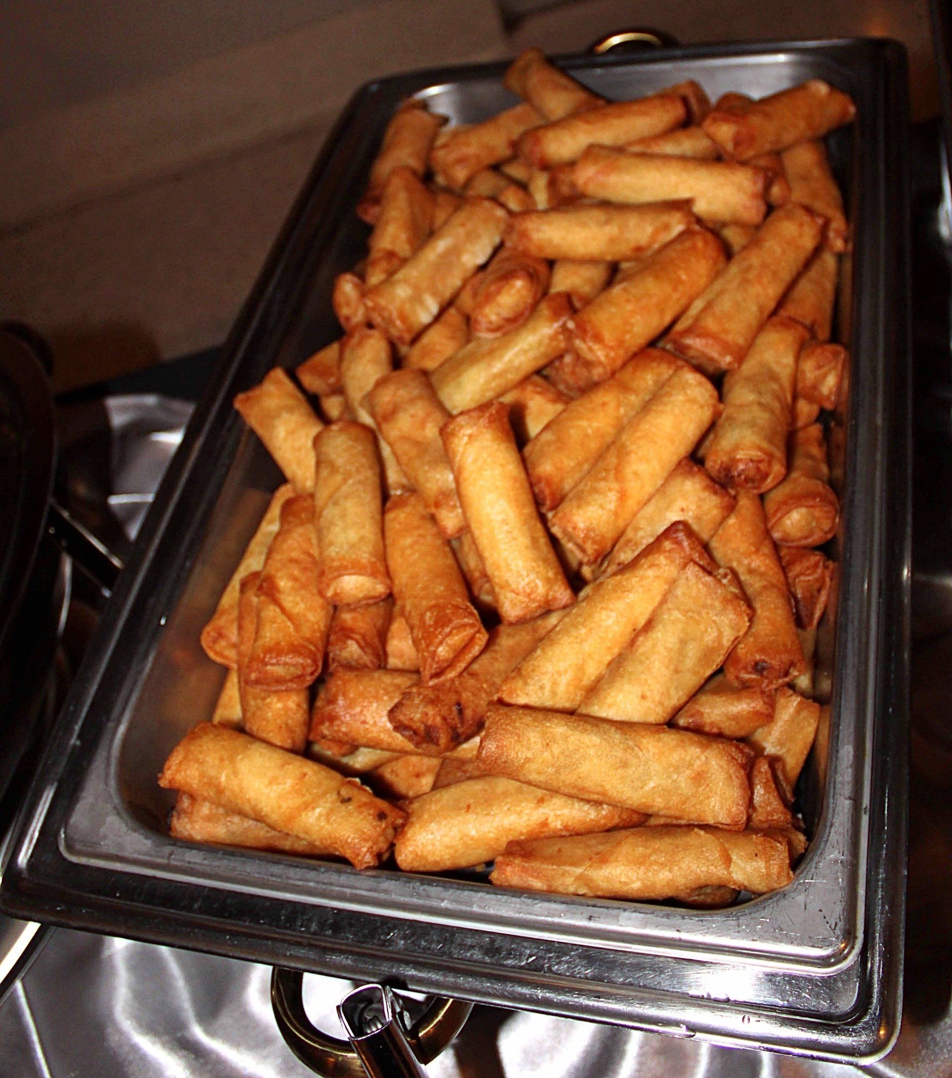 buffet pan filled with egg rolls