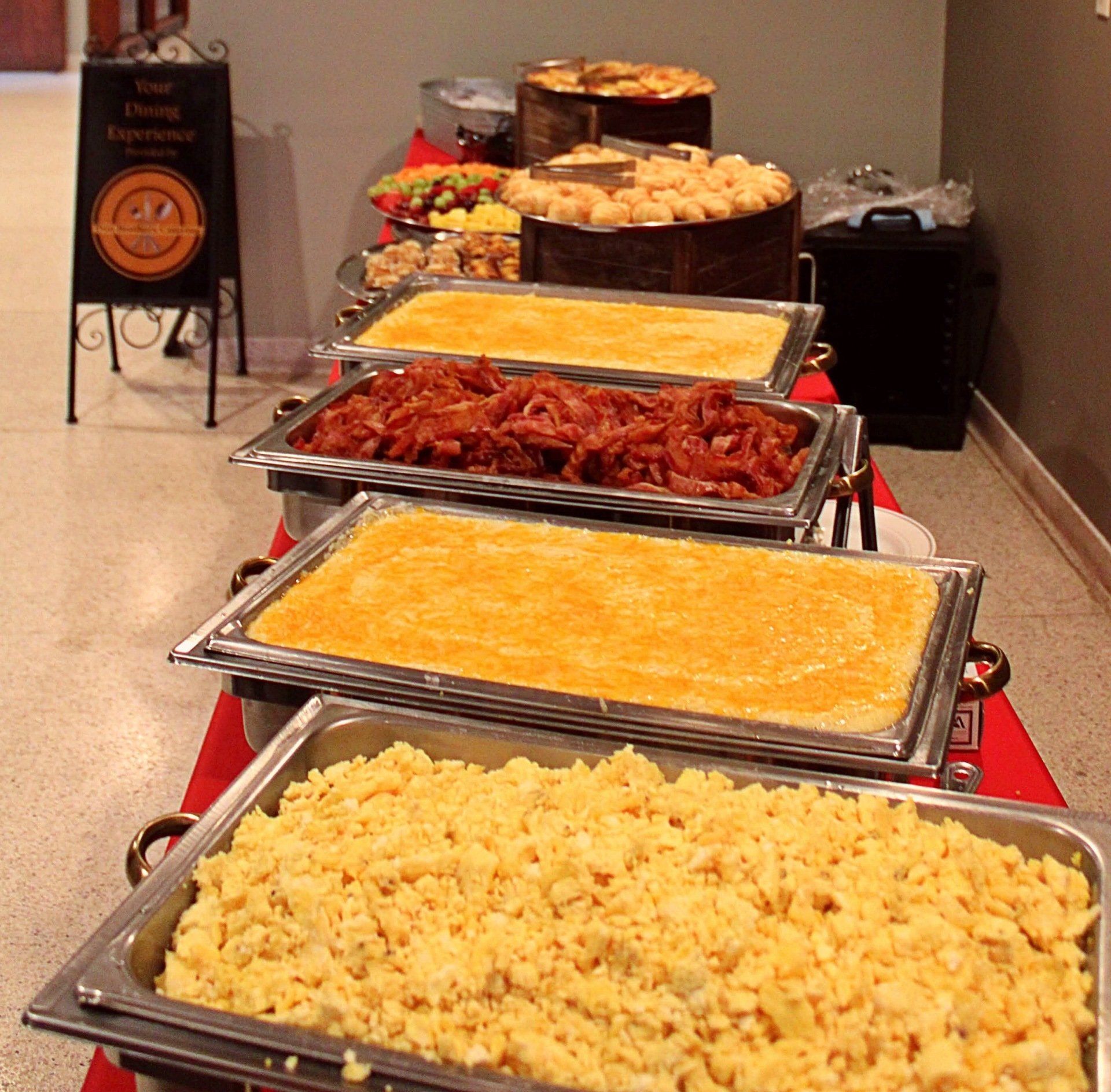 buffet pans lined up and filled with breakfast food
