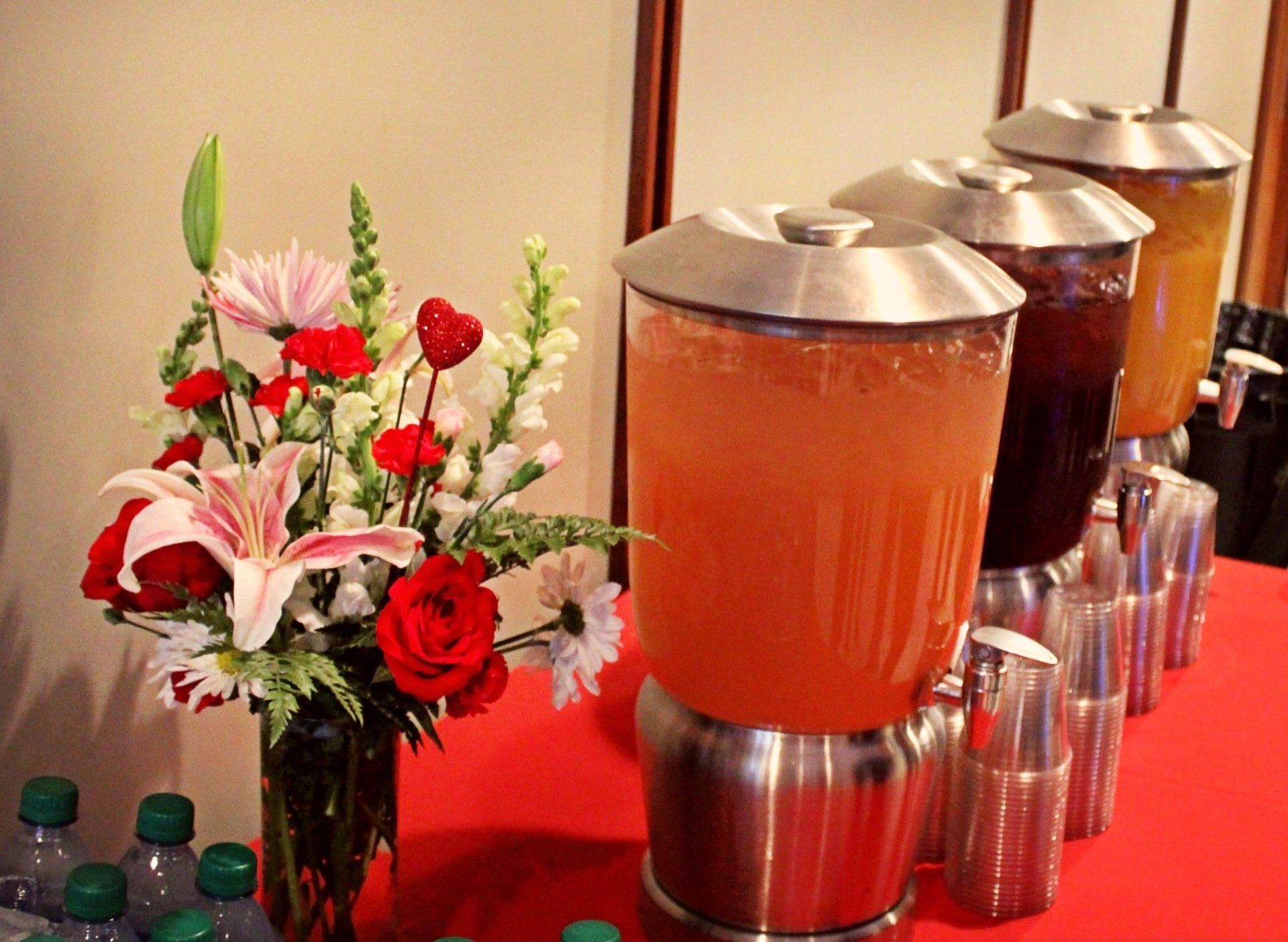 beverage jars lined on drink table with floral decor