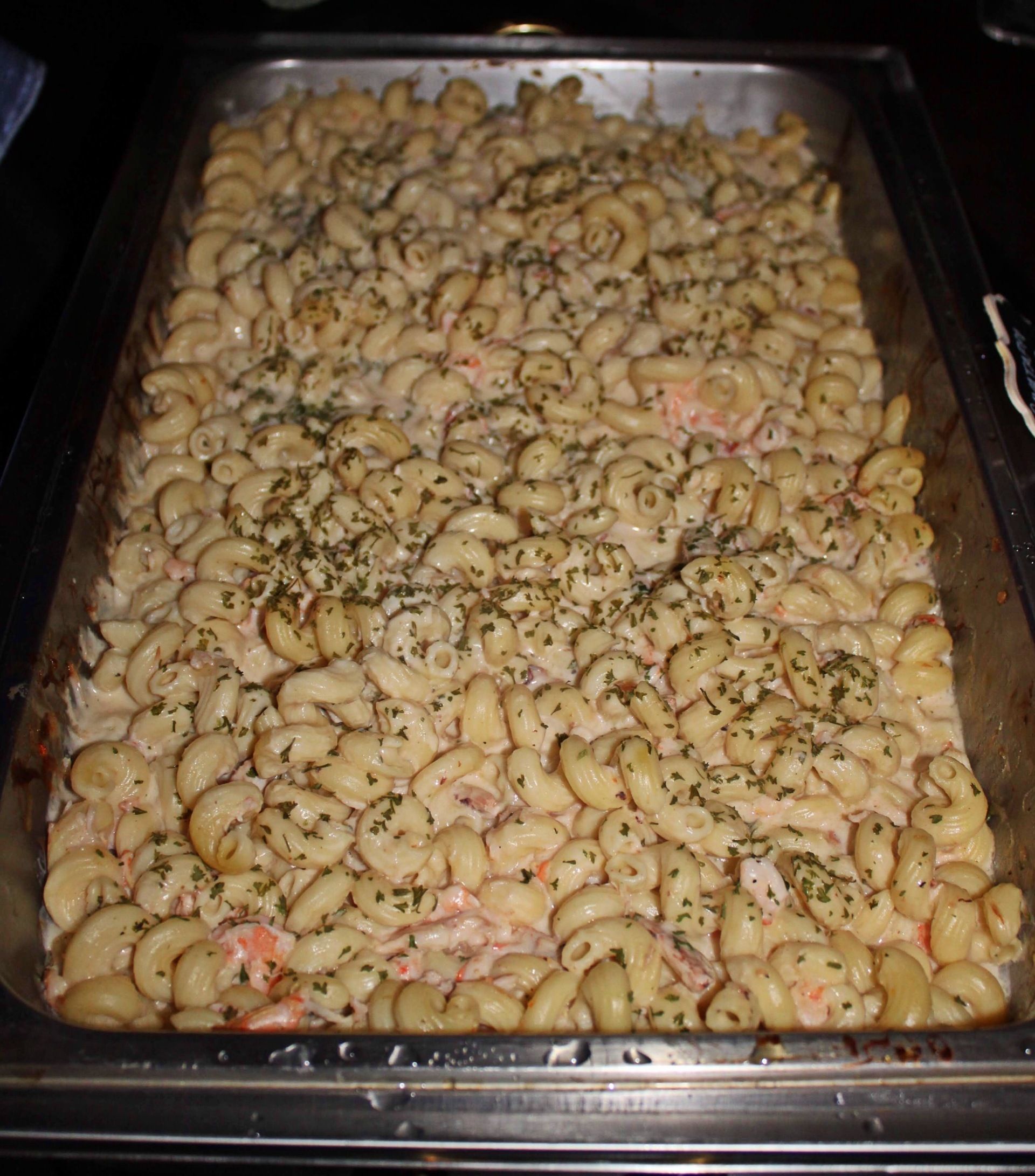 buffet tray filled with pasta shrip dish