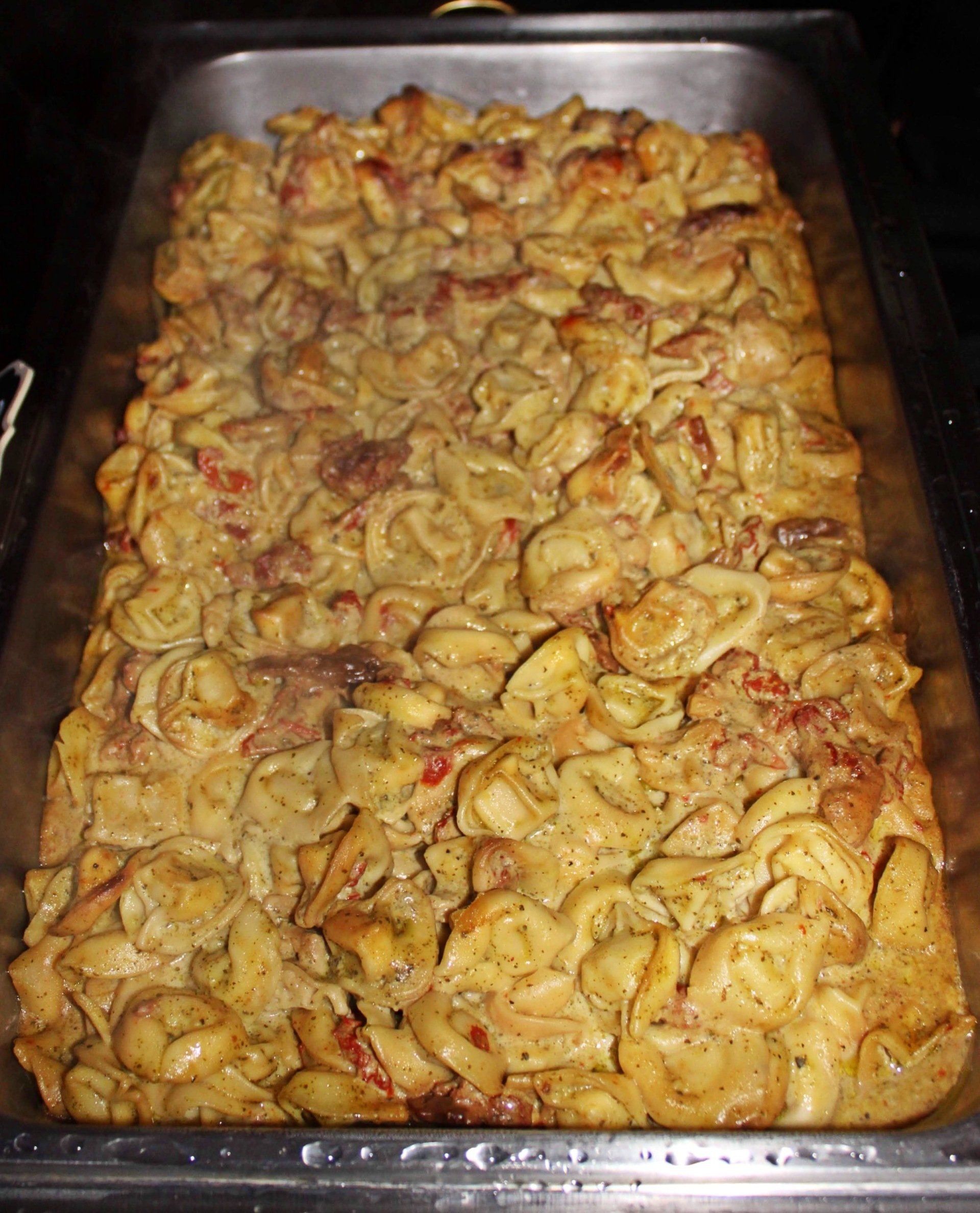 buffet pan filled with a tortellini pasta dish