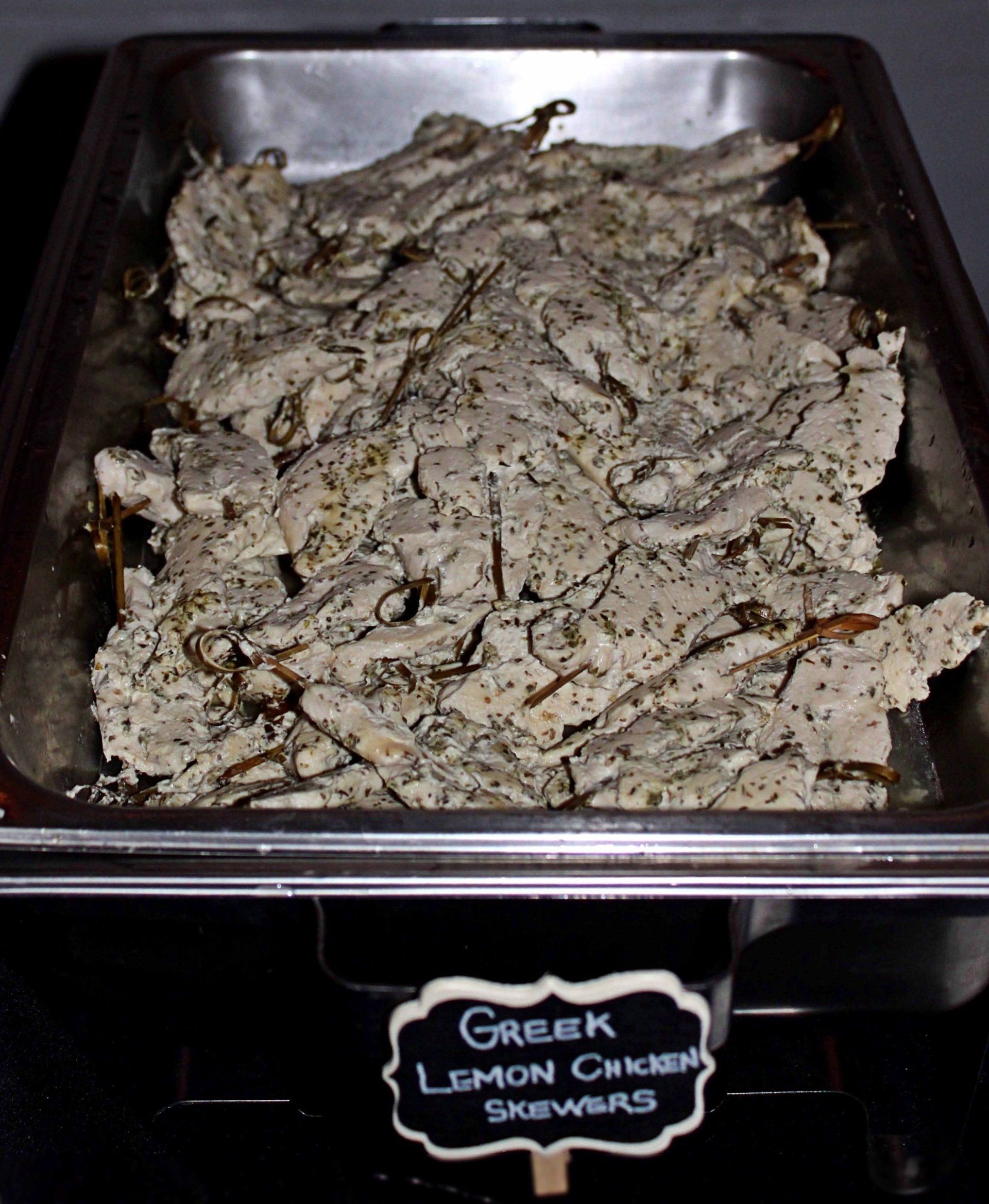 buffet pan filled with greek lemon chicken skewers