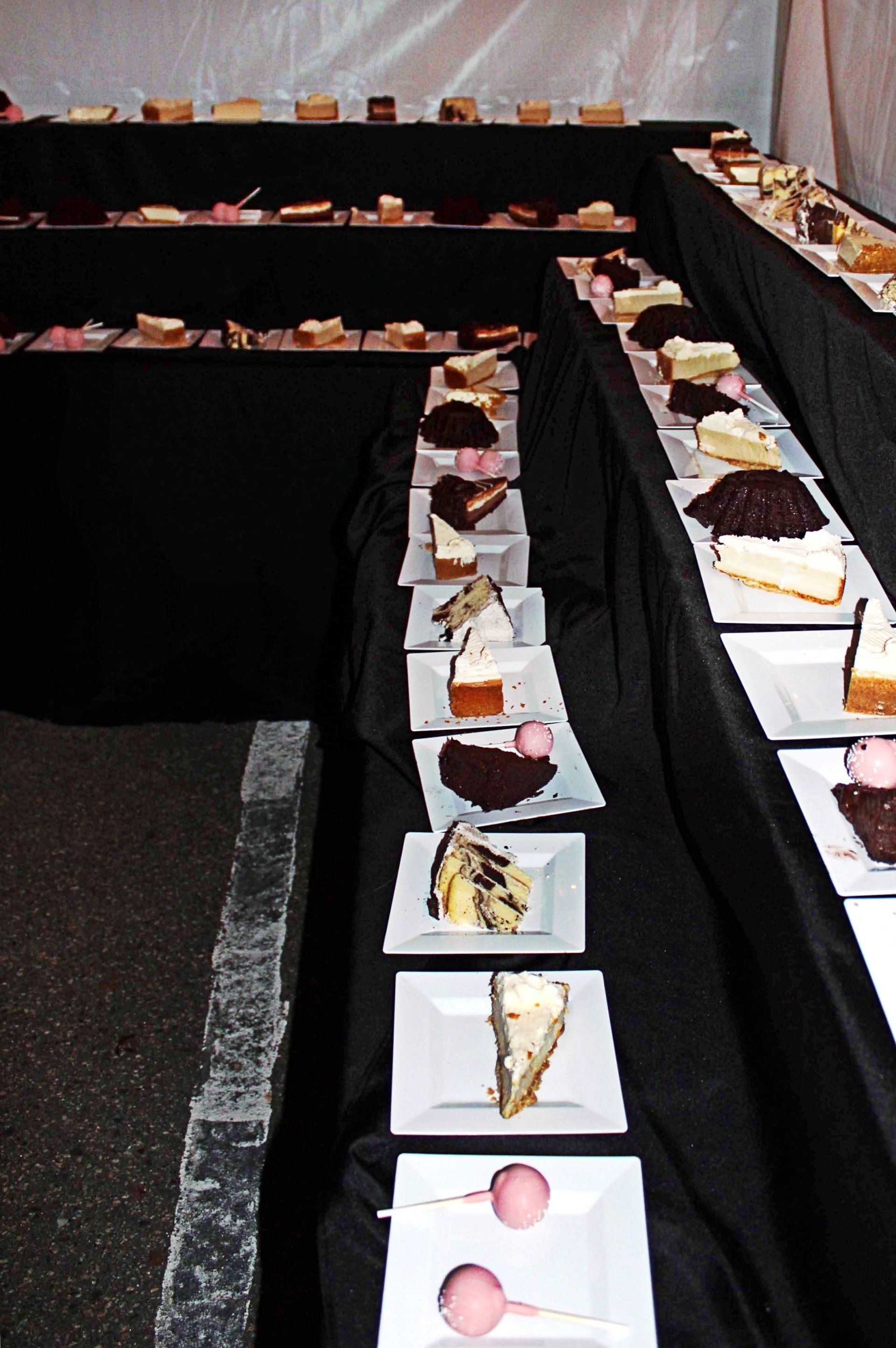 3 tiered long dessert table lined with assorted desserts