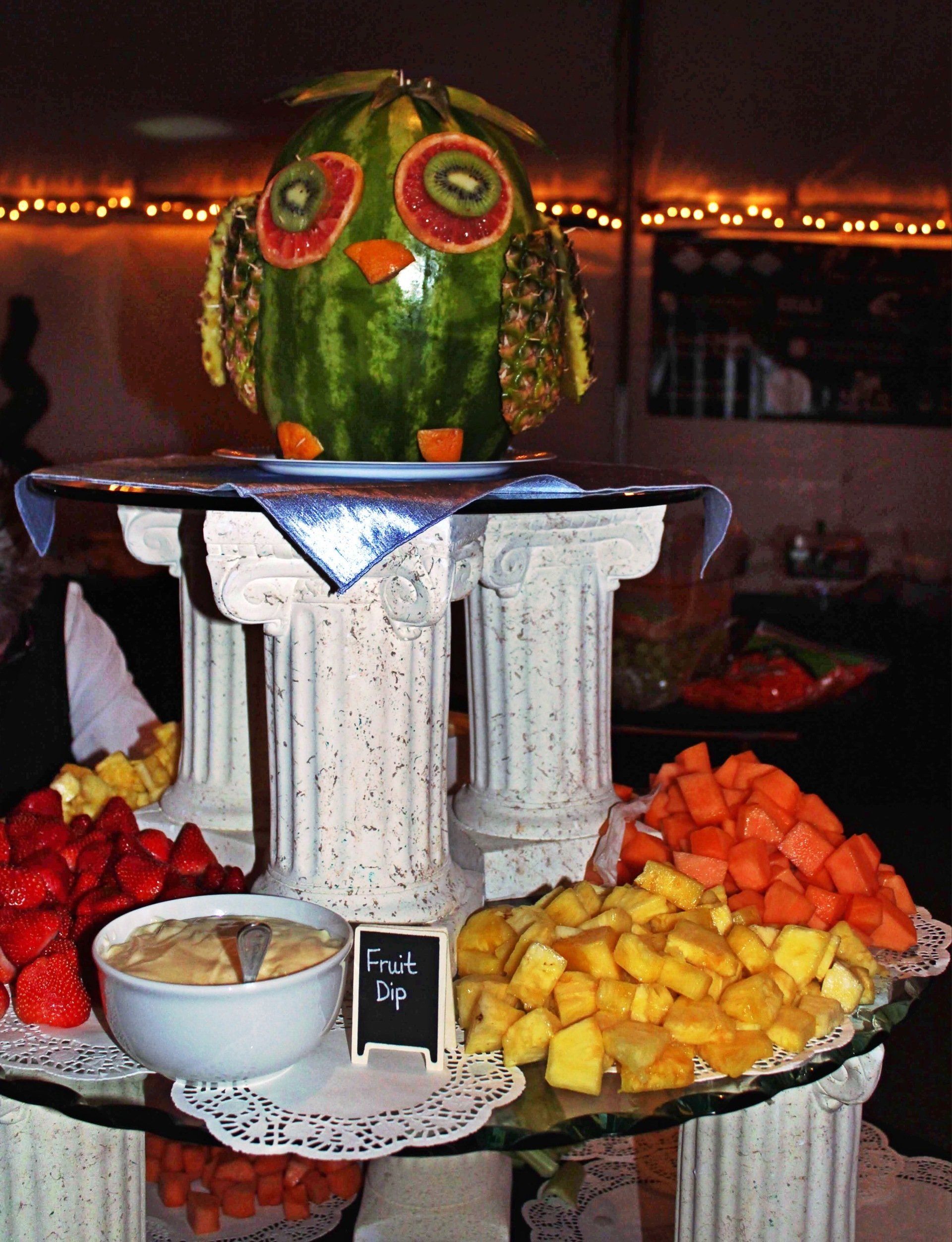 3 tiered fruit and vegetable display showing fruit and fruit owl display on top