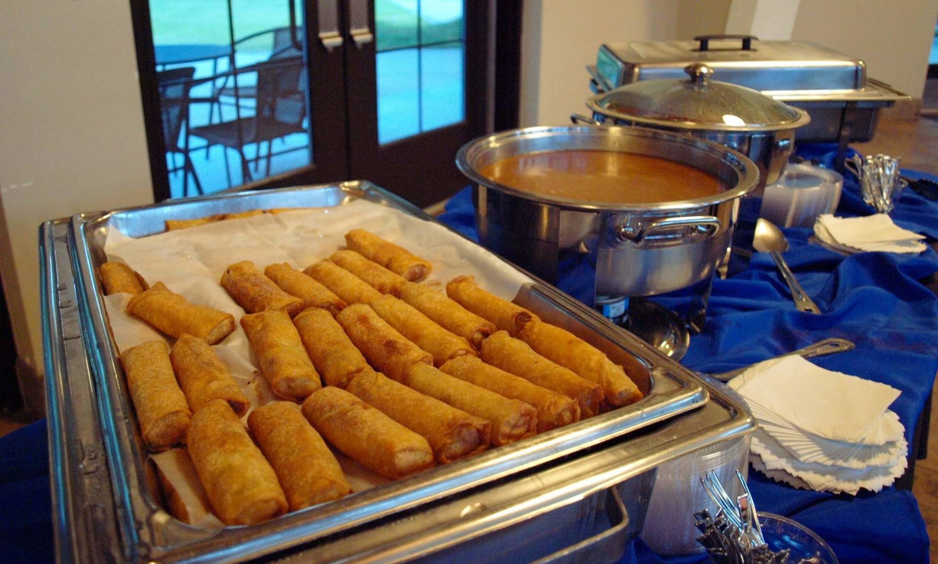 a buffet pan filled with egg rolls