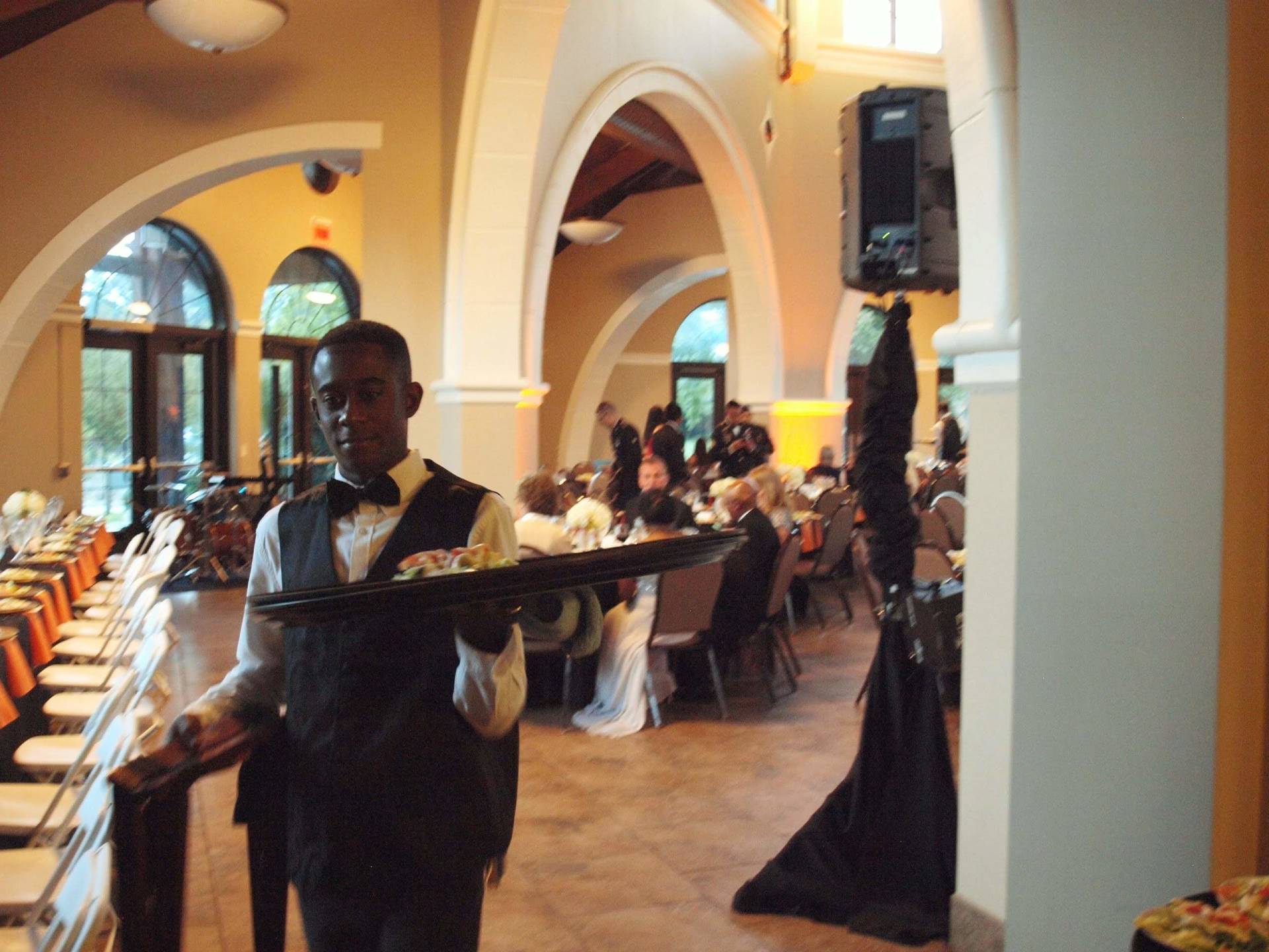 a male caterer carrying a tray