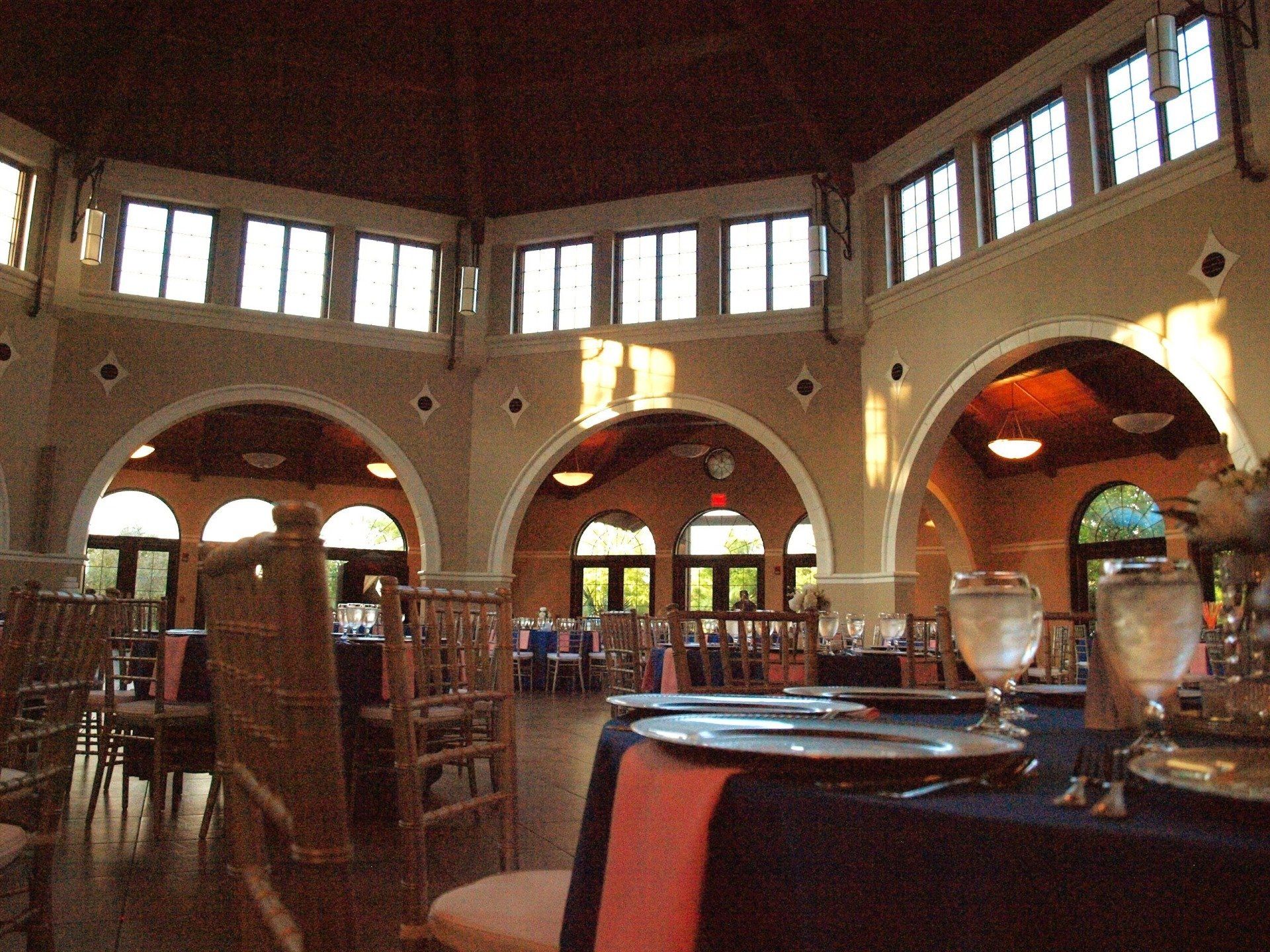 room of round tables set for guests