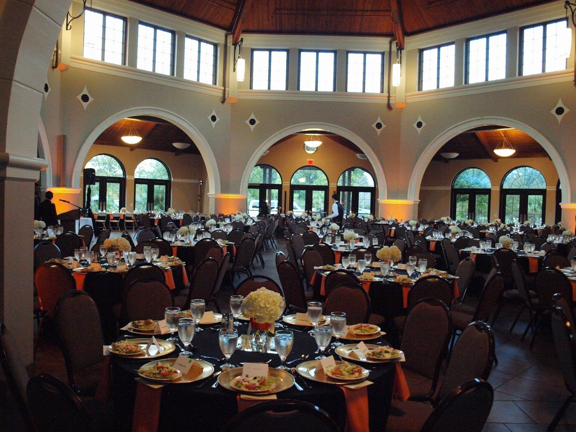 room of round tables set for guests