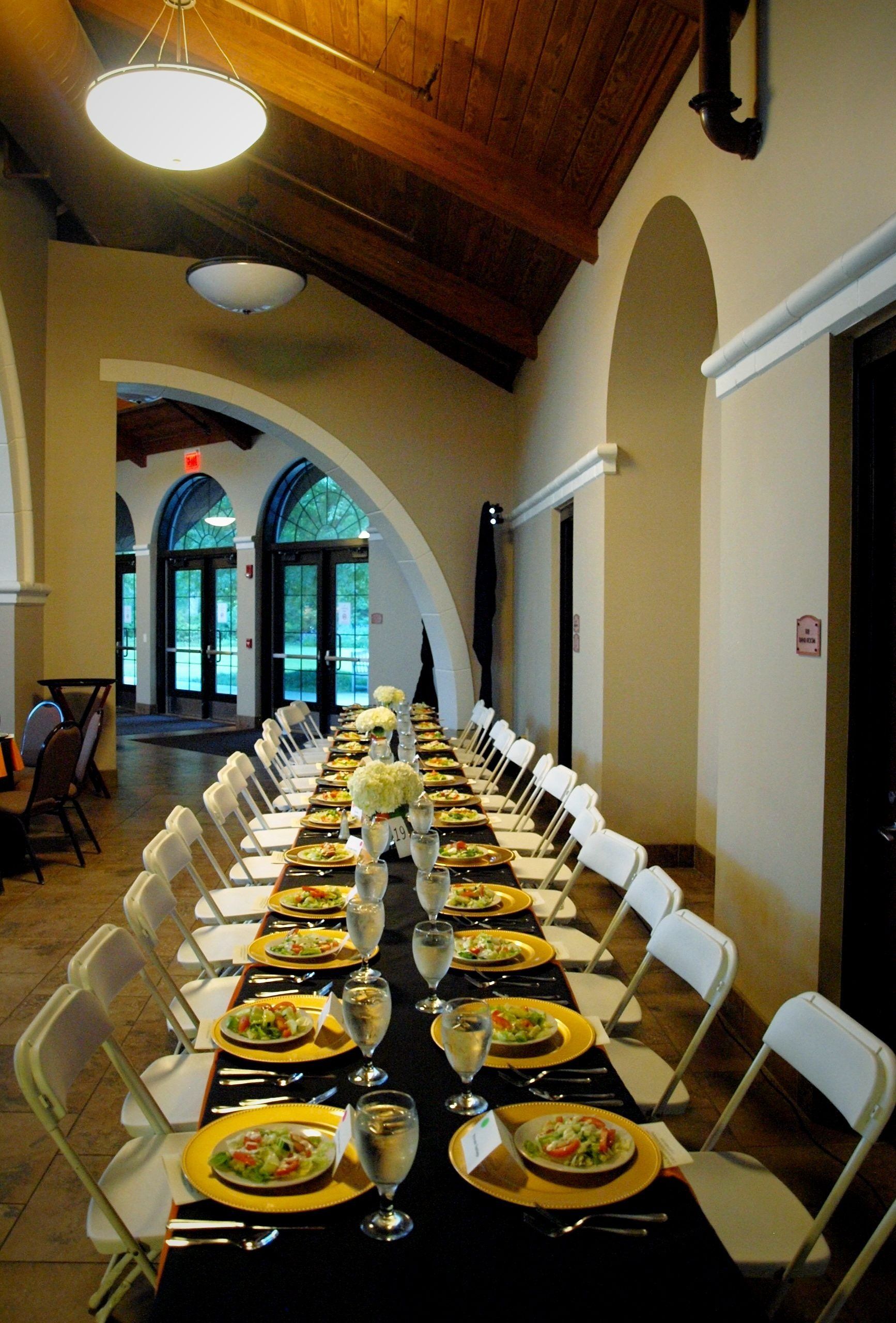 long rectangular table set with plated salads