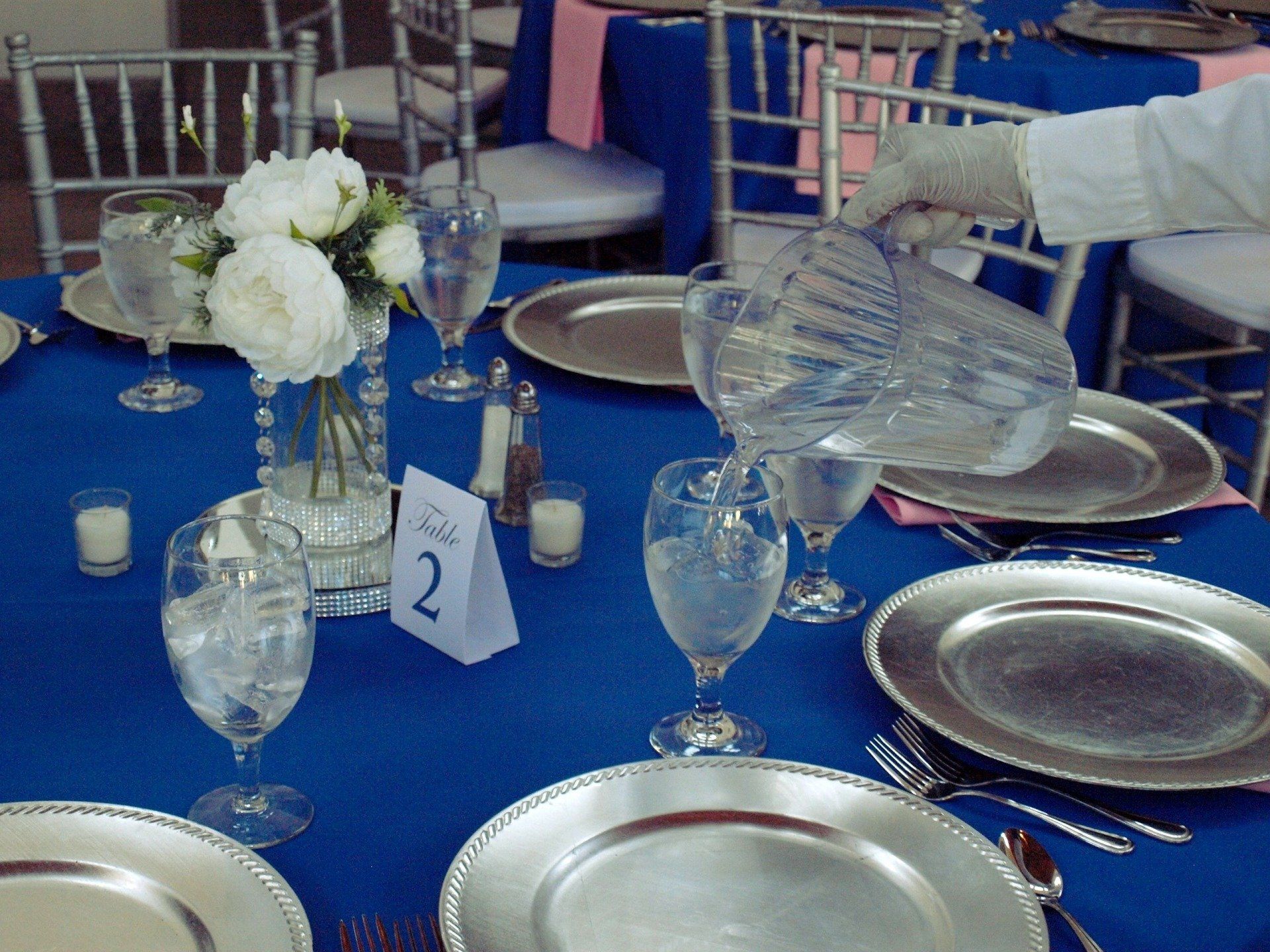 caterer filling glass with water