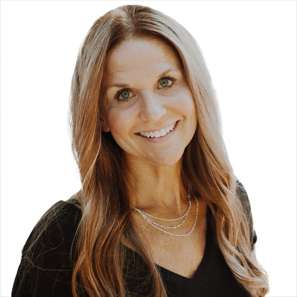 A woman wearing a black shirt and a necklace is smiling for the camera.