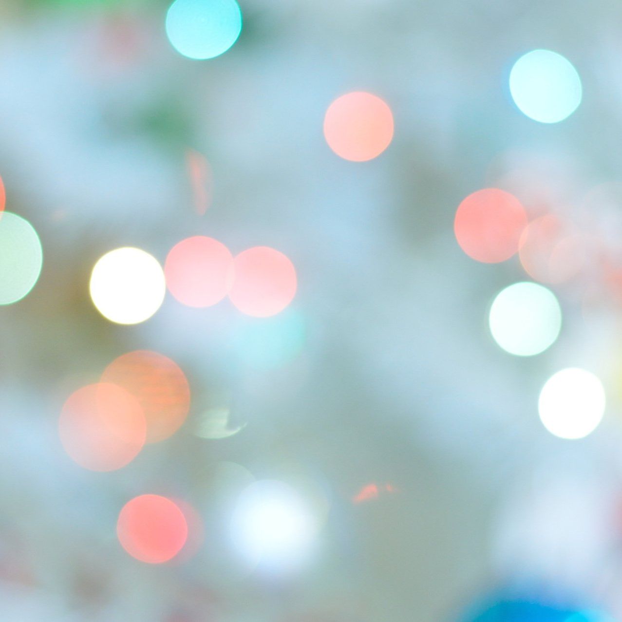 A blurry picture of christmas lights on a tree.