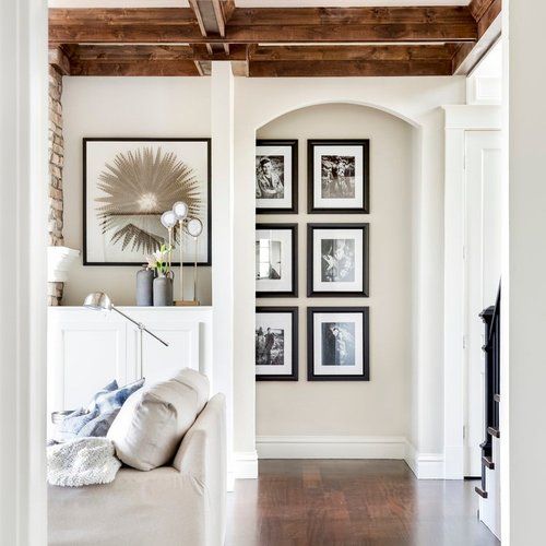 Denver interior design project by Ashley Campbell featuring a hallway gallery wall of framed family photos in a luxury home
