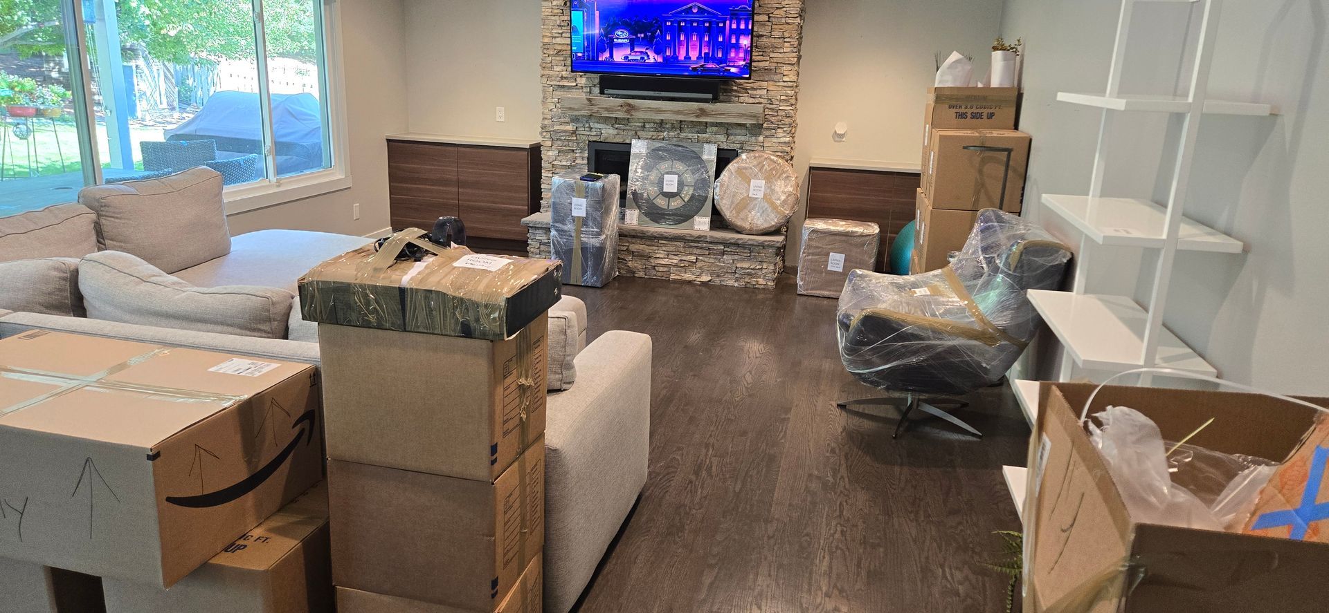 A man is taping a cardboard box with tape.