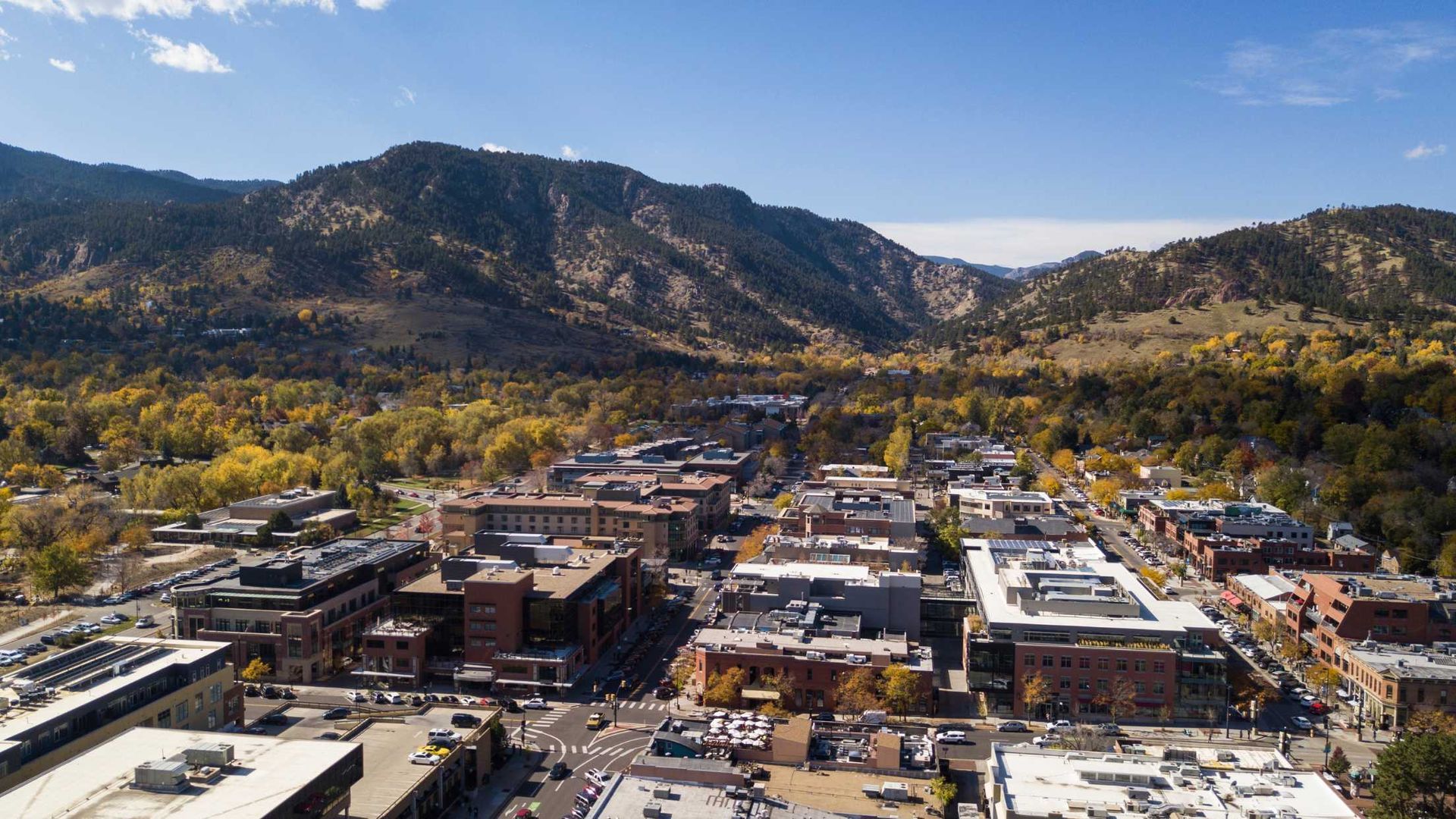 An aerial view of a city with mountains in the background.