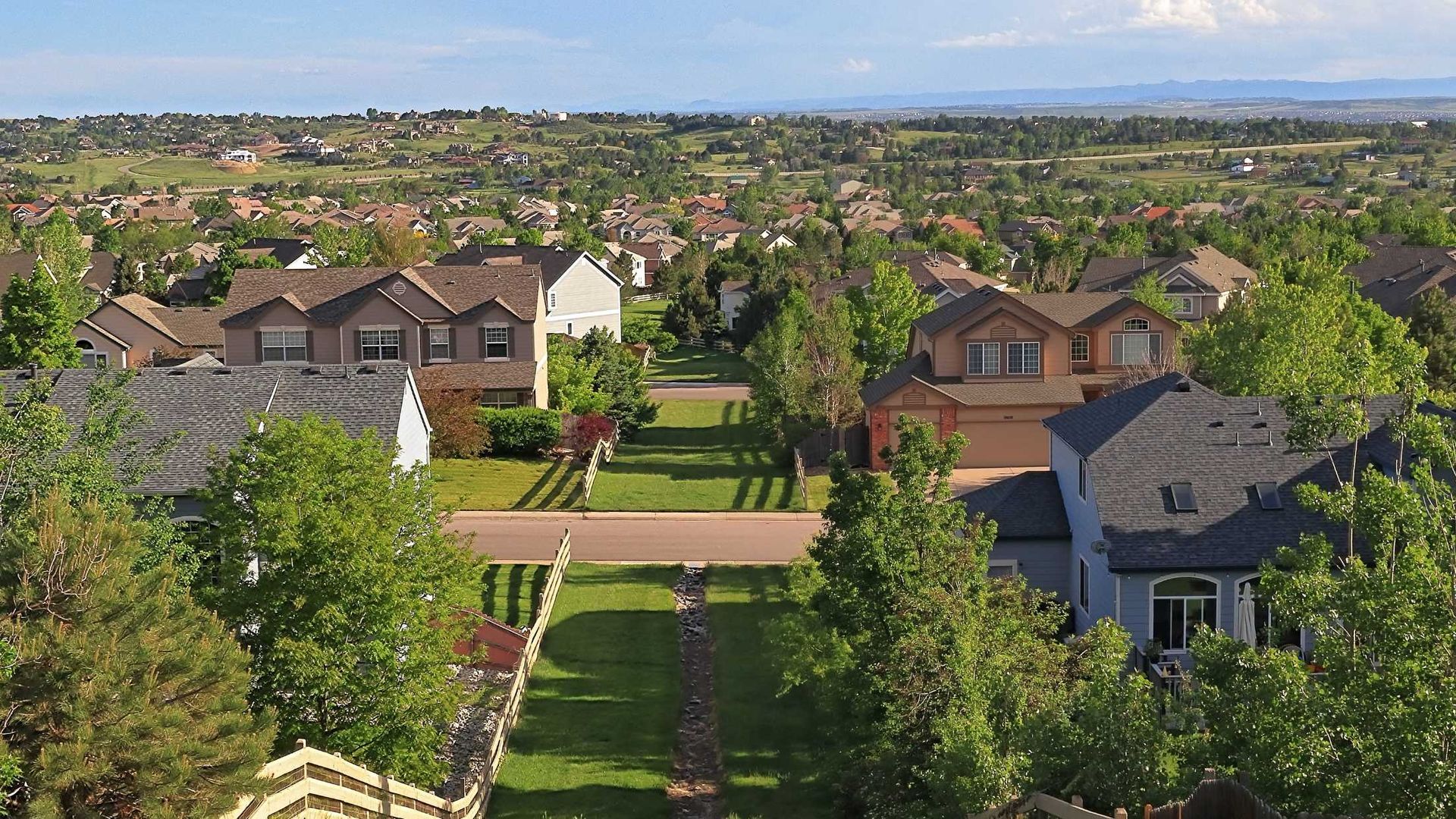 An aerial view of a residential area with houses and trees