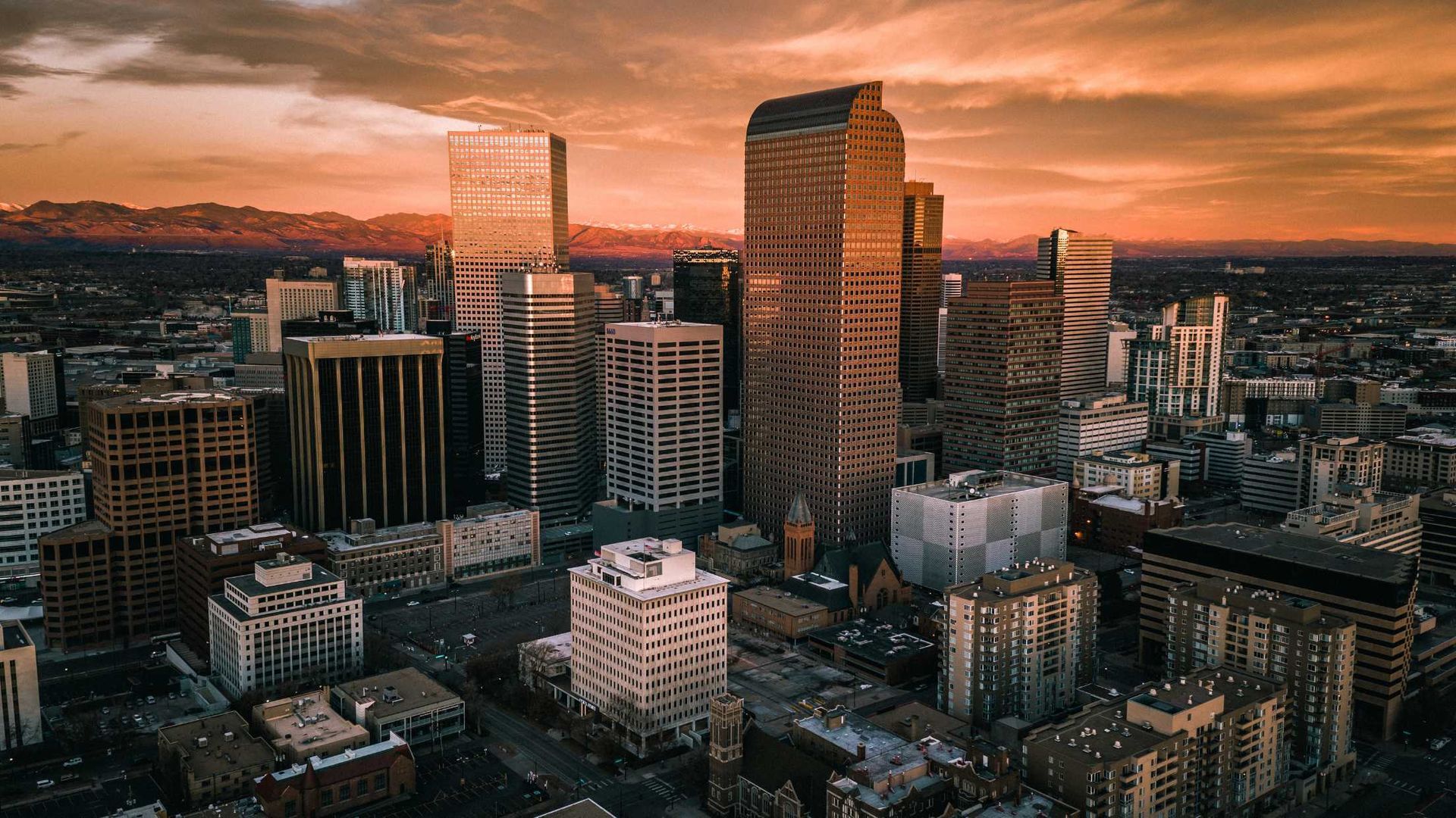 An aerial view of a city skyline at sunset.
