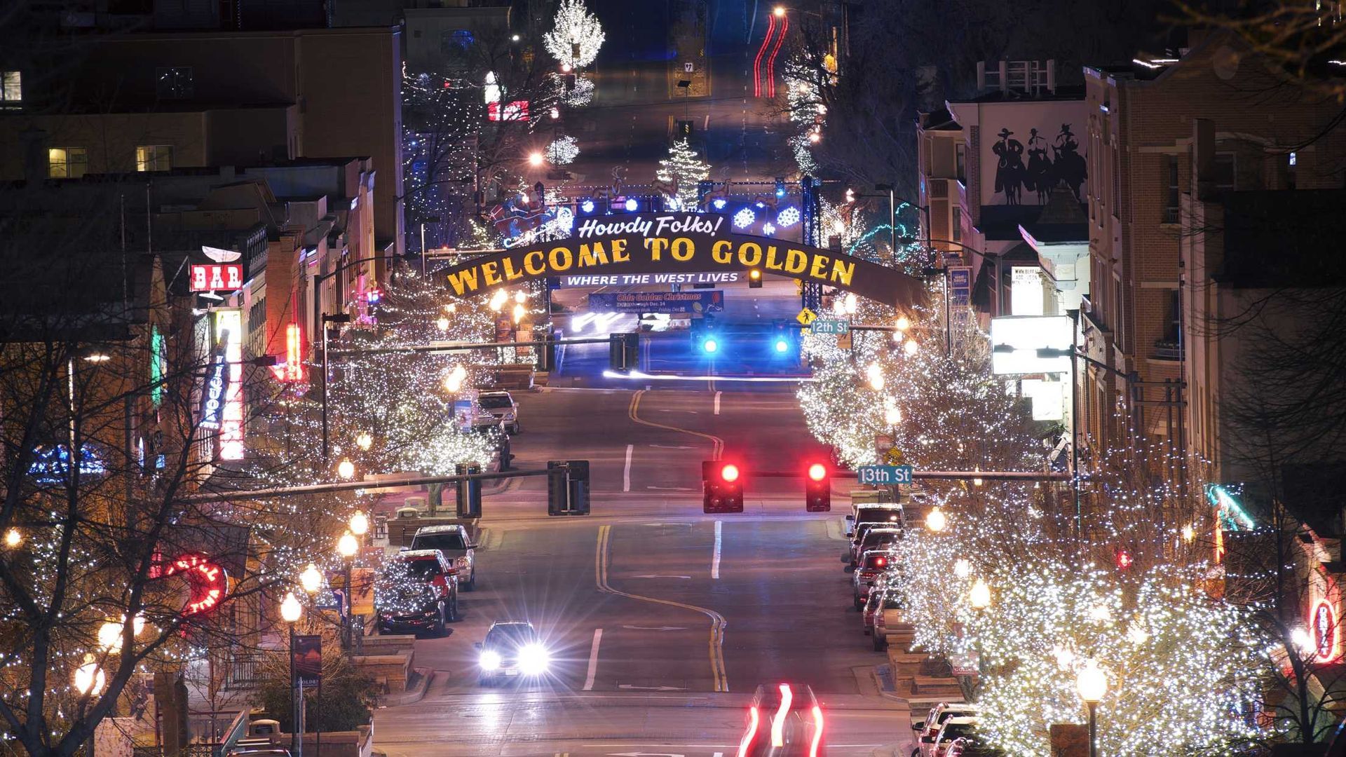 An aerial view of a city street with a sign that says welcome to golden