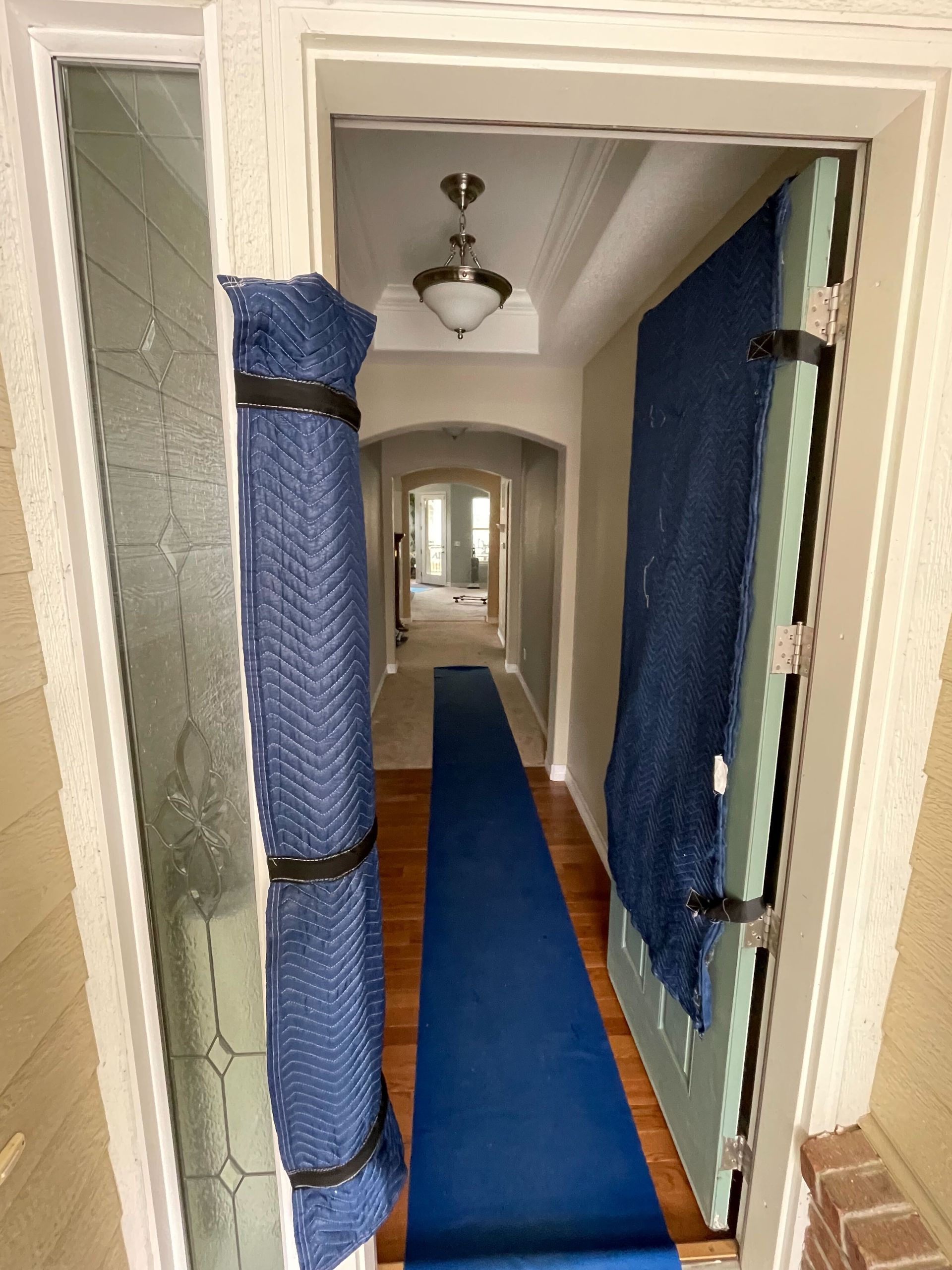 A man and a woman are standing in front of a moving truck.