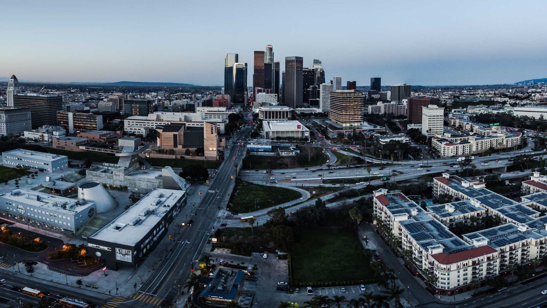 An aerial view of a city with a lot of buildings and a lot of traffic.