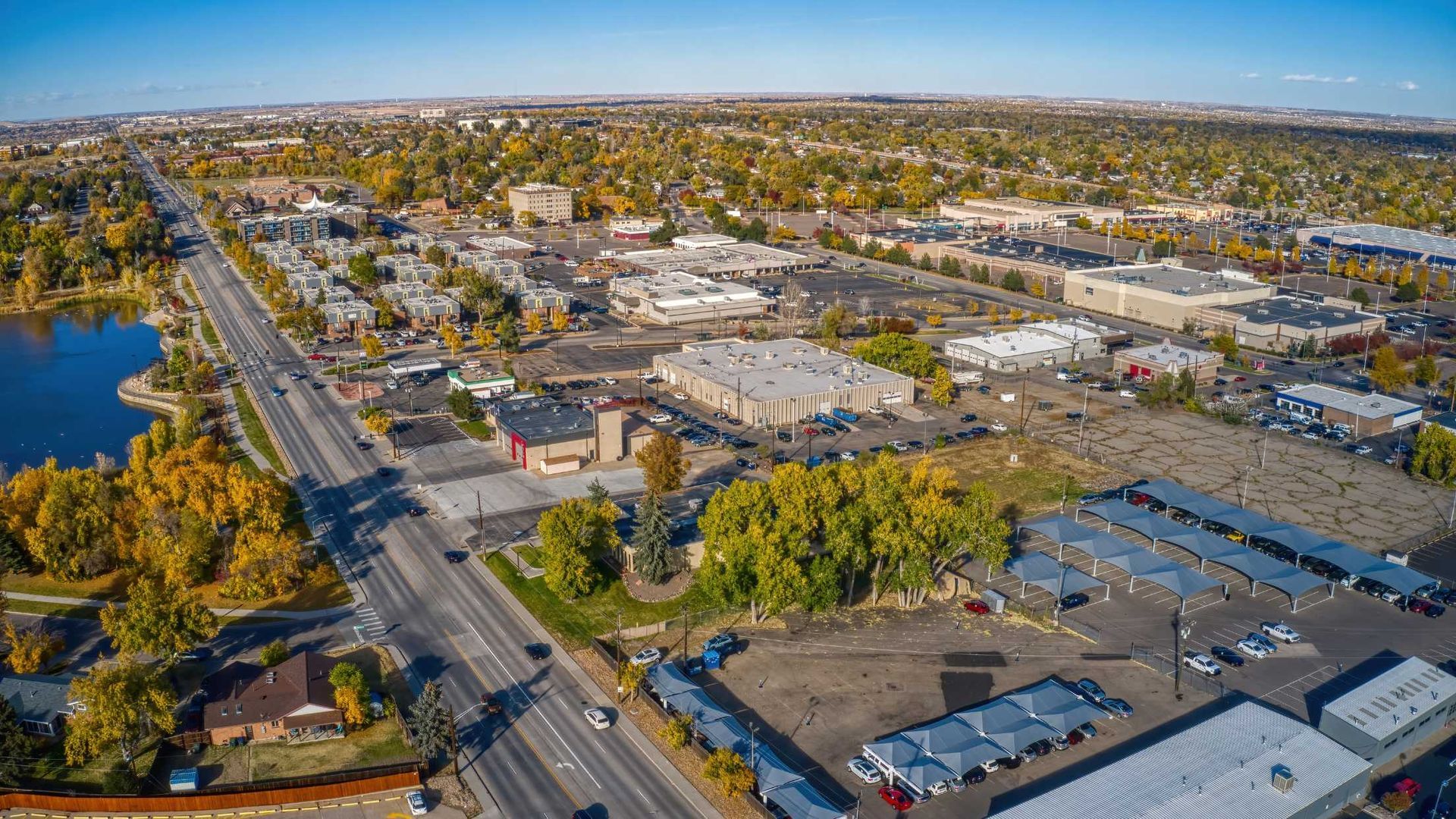 An aerial view of a city with a lake in the middle of it.